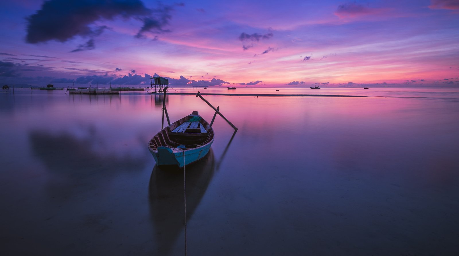 brown boat on body of water sunrise phu quoc island ocean 2k 4k