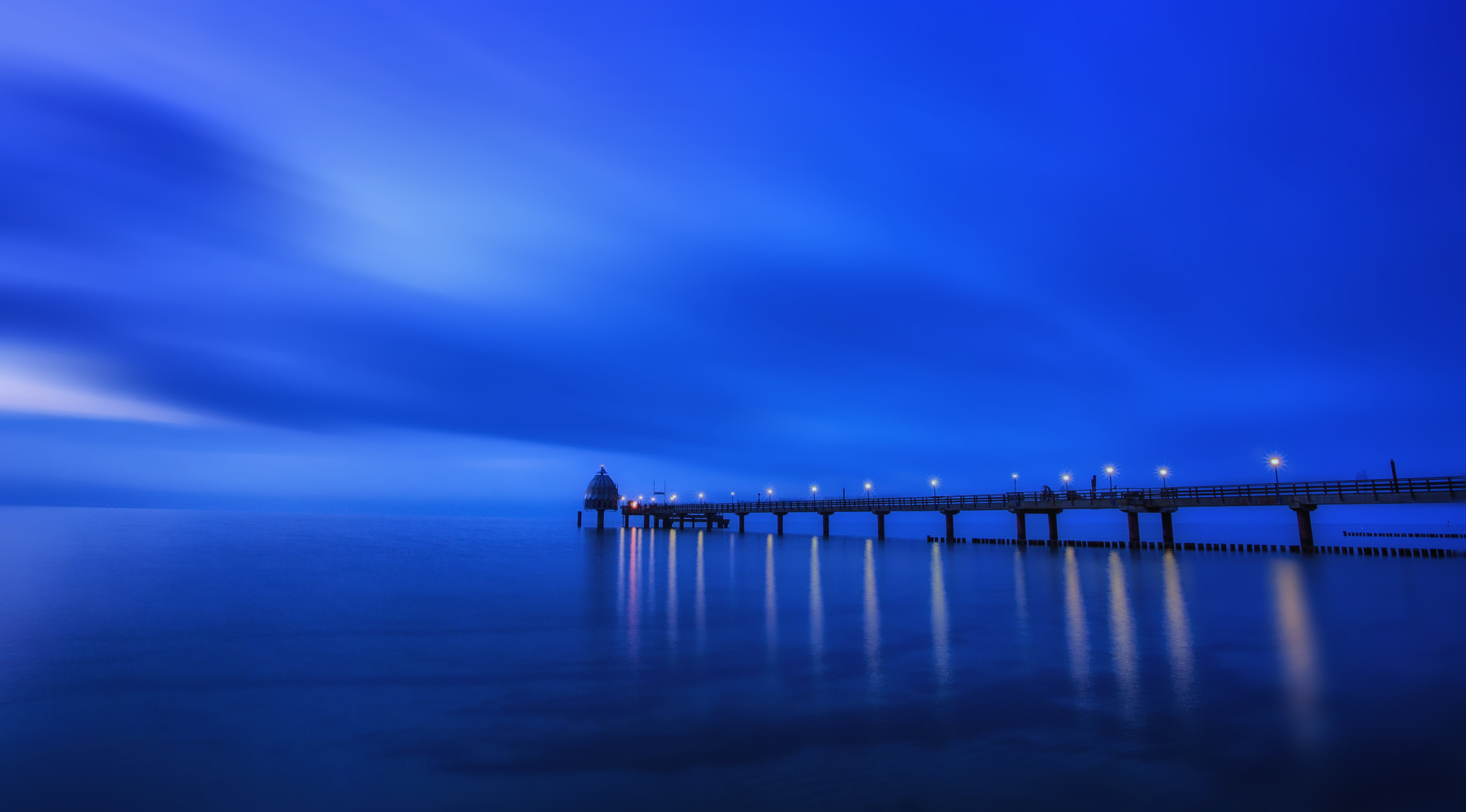 dock near body of water during night time blue horizon hour 2k 4k 5k