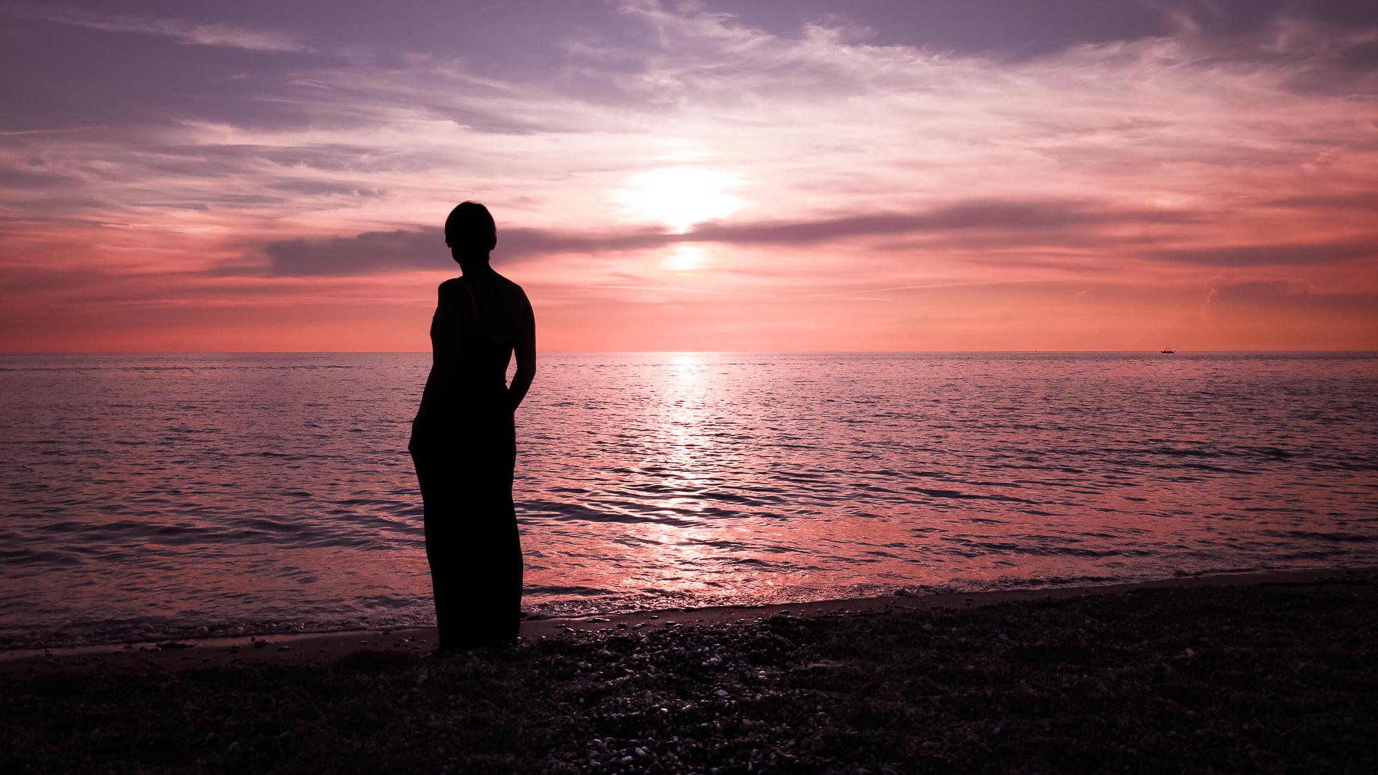 silhouette of woman in shirt watching seashore during golden hour paola italy 2k