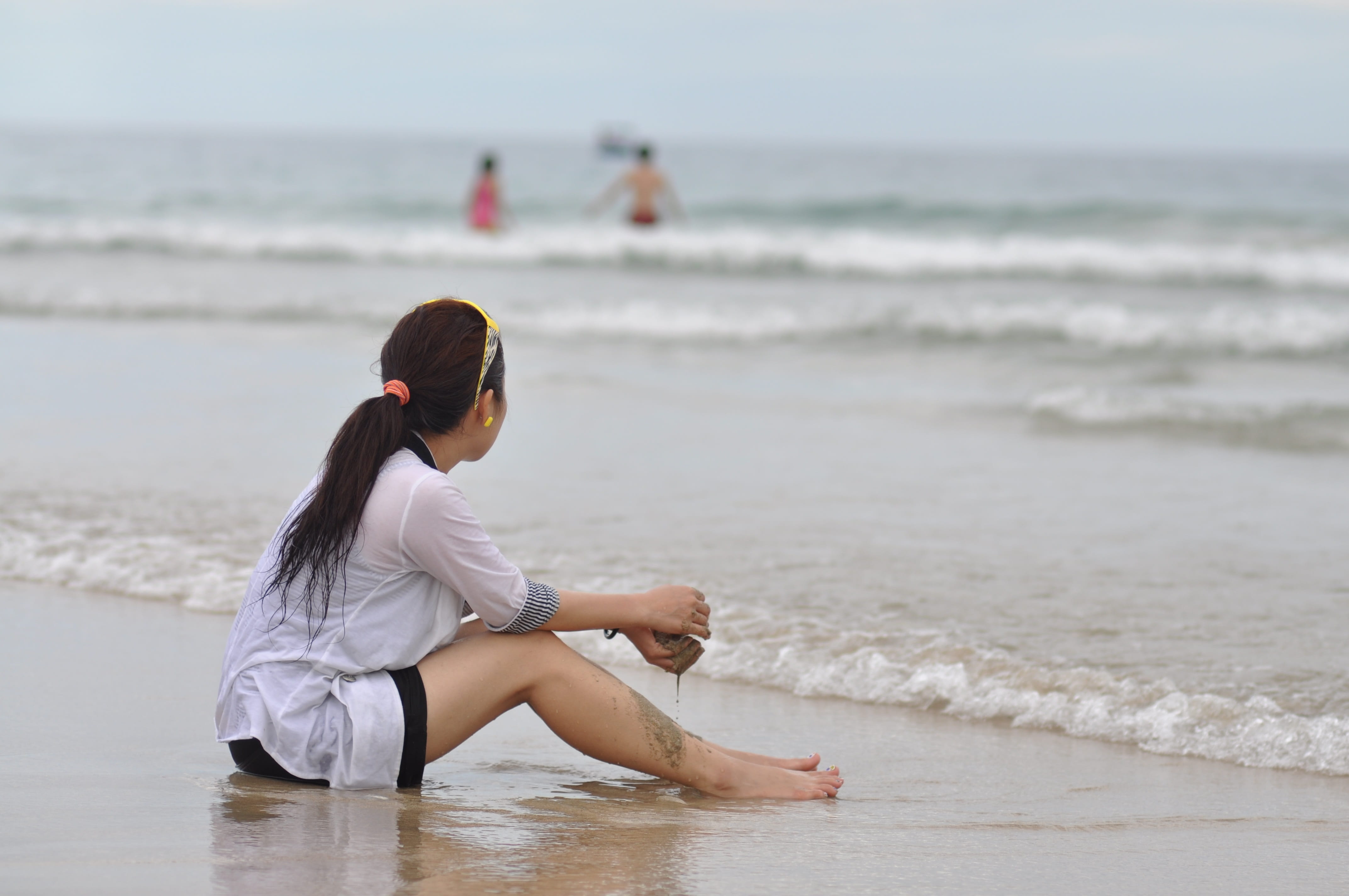 woman wearing white shirt sitting on seashore girl beach sad 2k 4k