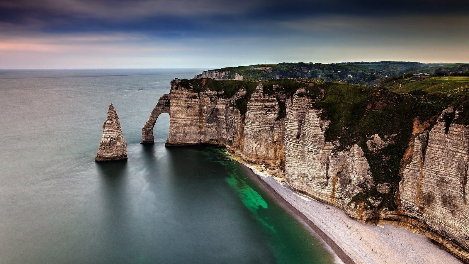 body of water and rock formations nature landscape sea clouds 2k