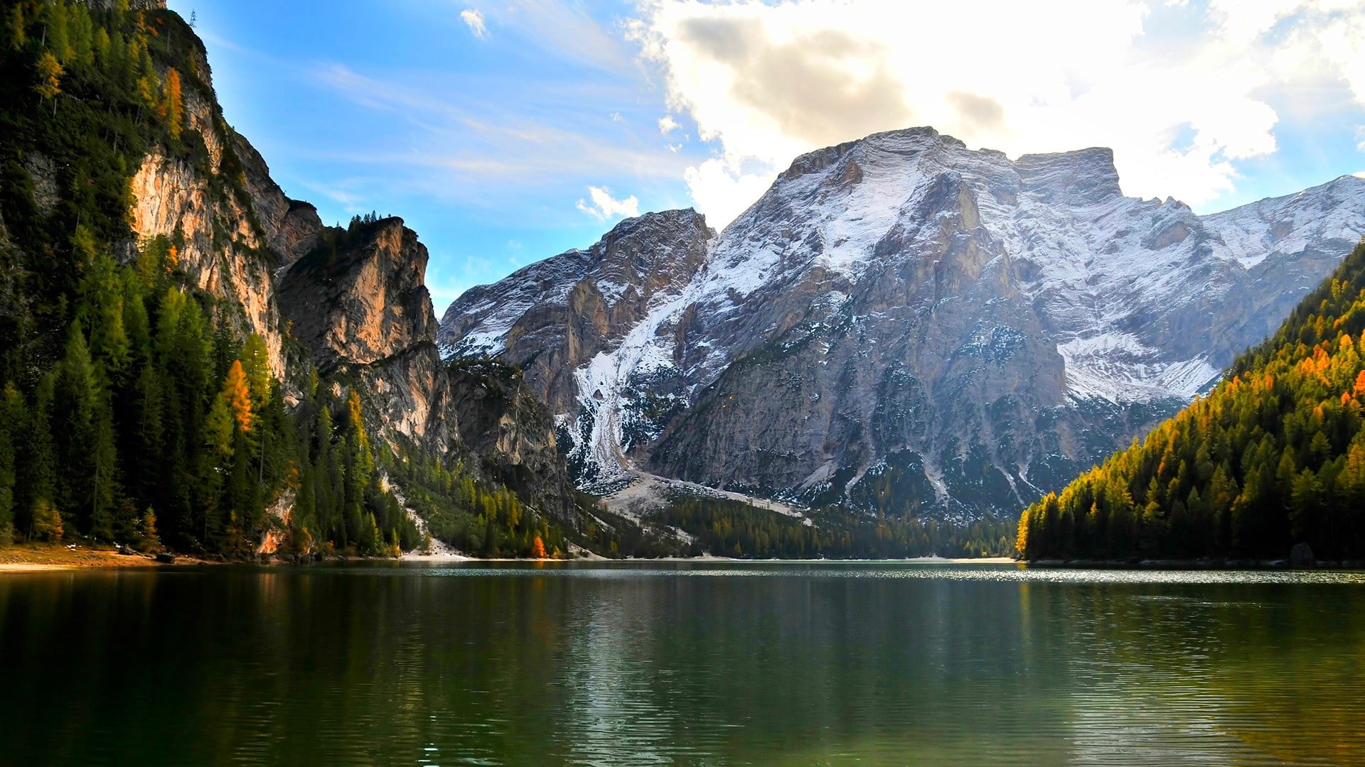 ice capped mountain beside calm water mountains near body of under cloudy sky during daytime 2k