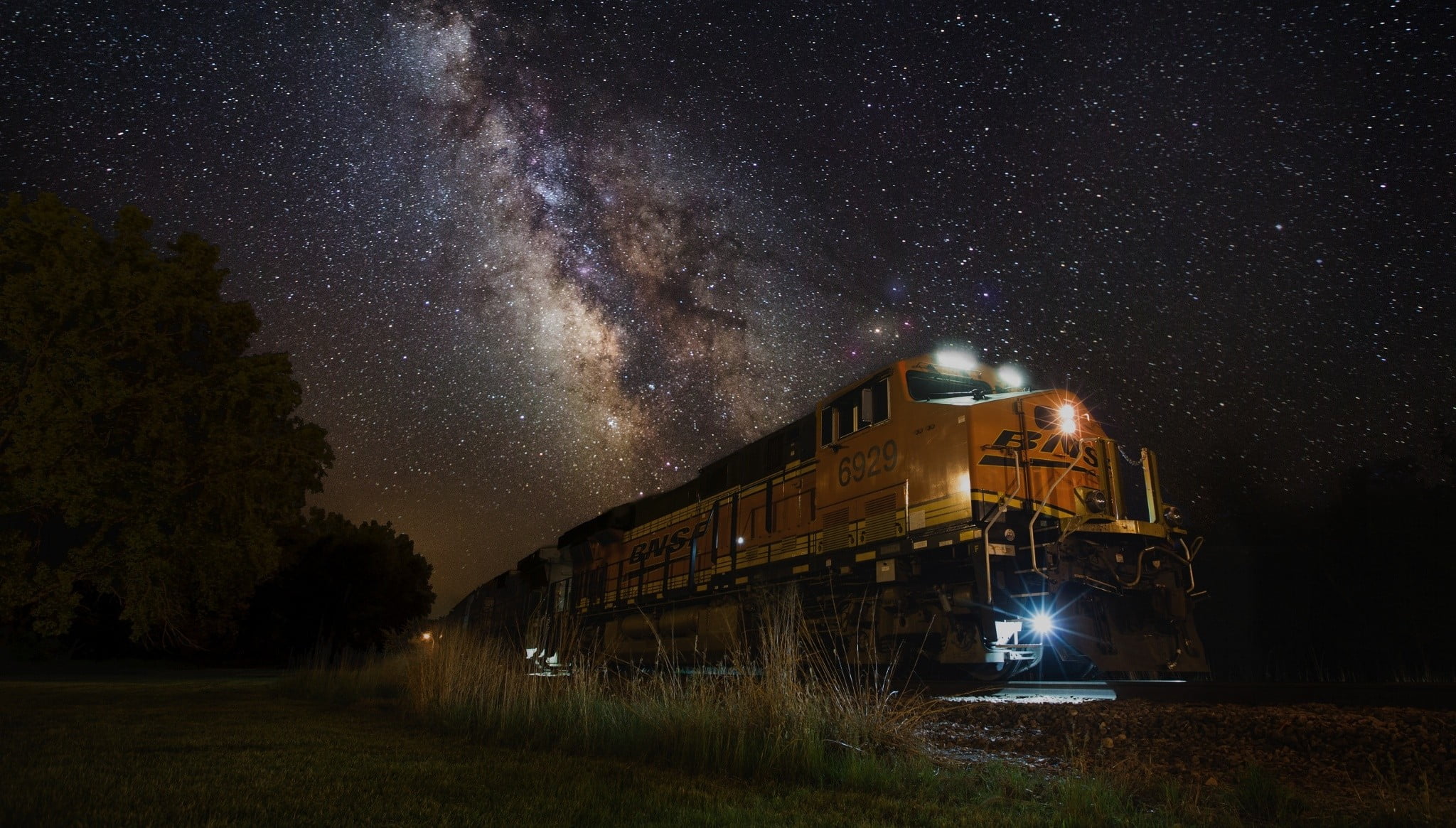 yellow train night lights Milky Way landscape nature galaxy 2k