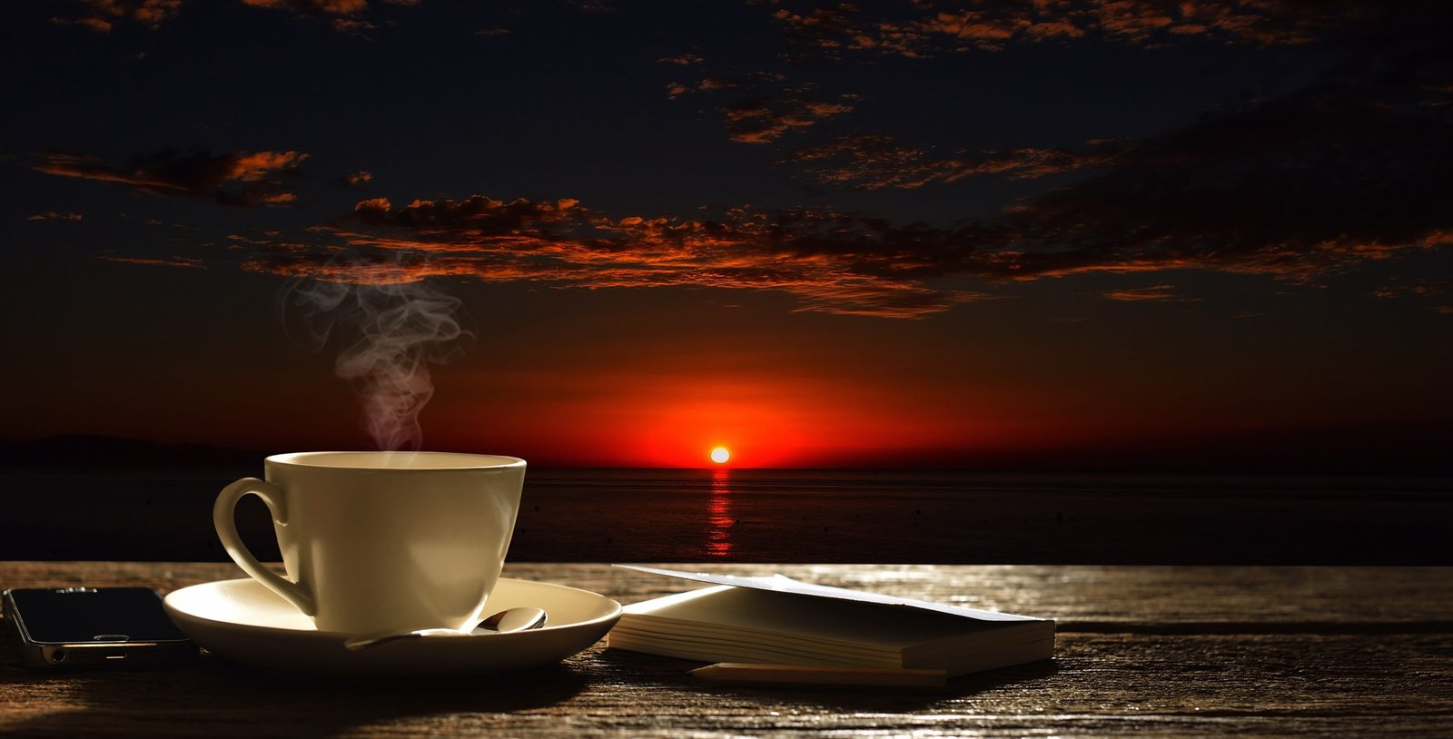 white ceramic teacup with saucer beside the book Sky Coffe 2k 4k 5k