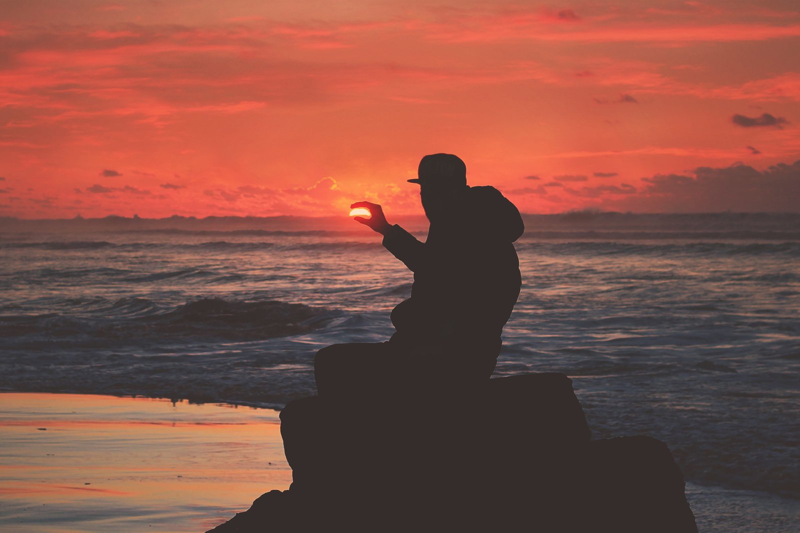 Silhouette of a man on the coast at sunset people beach nature 2k 4k
