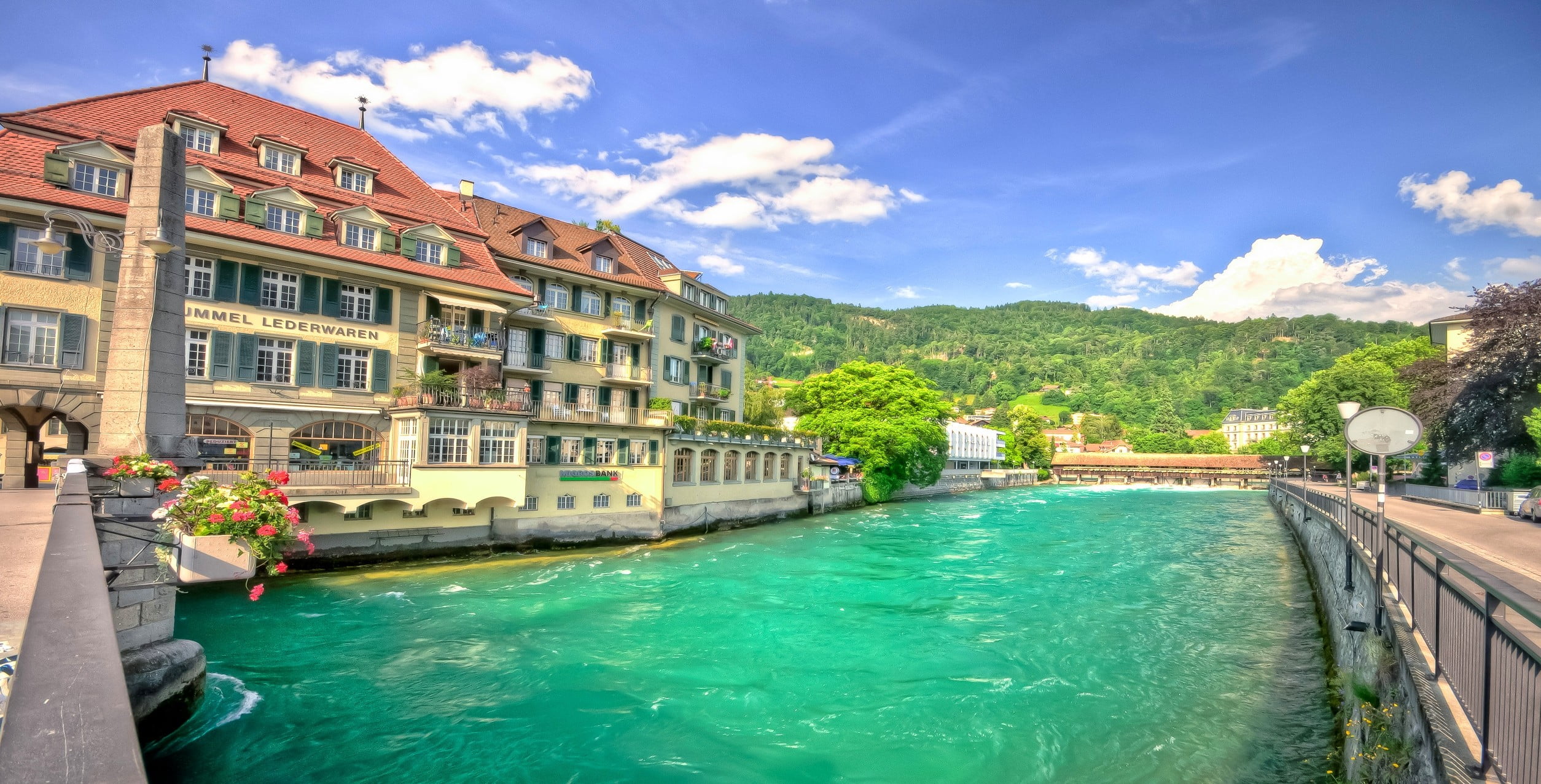white and brown concrete building body of water Switzerland 2k