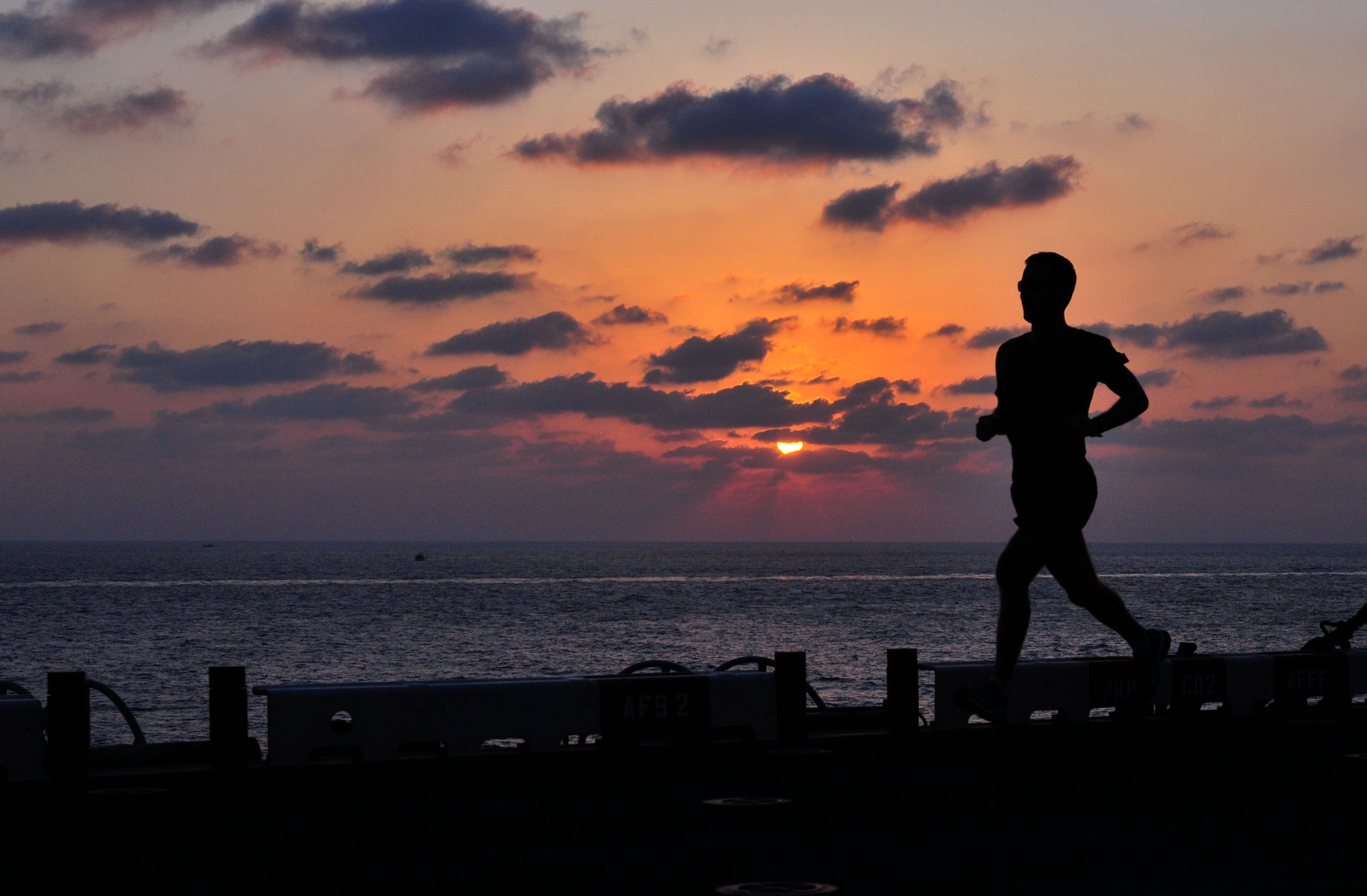 silhouette photo of man while running runner fitness ship 2k