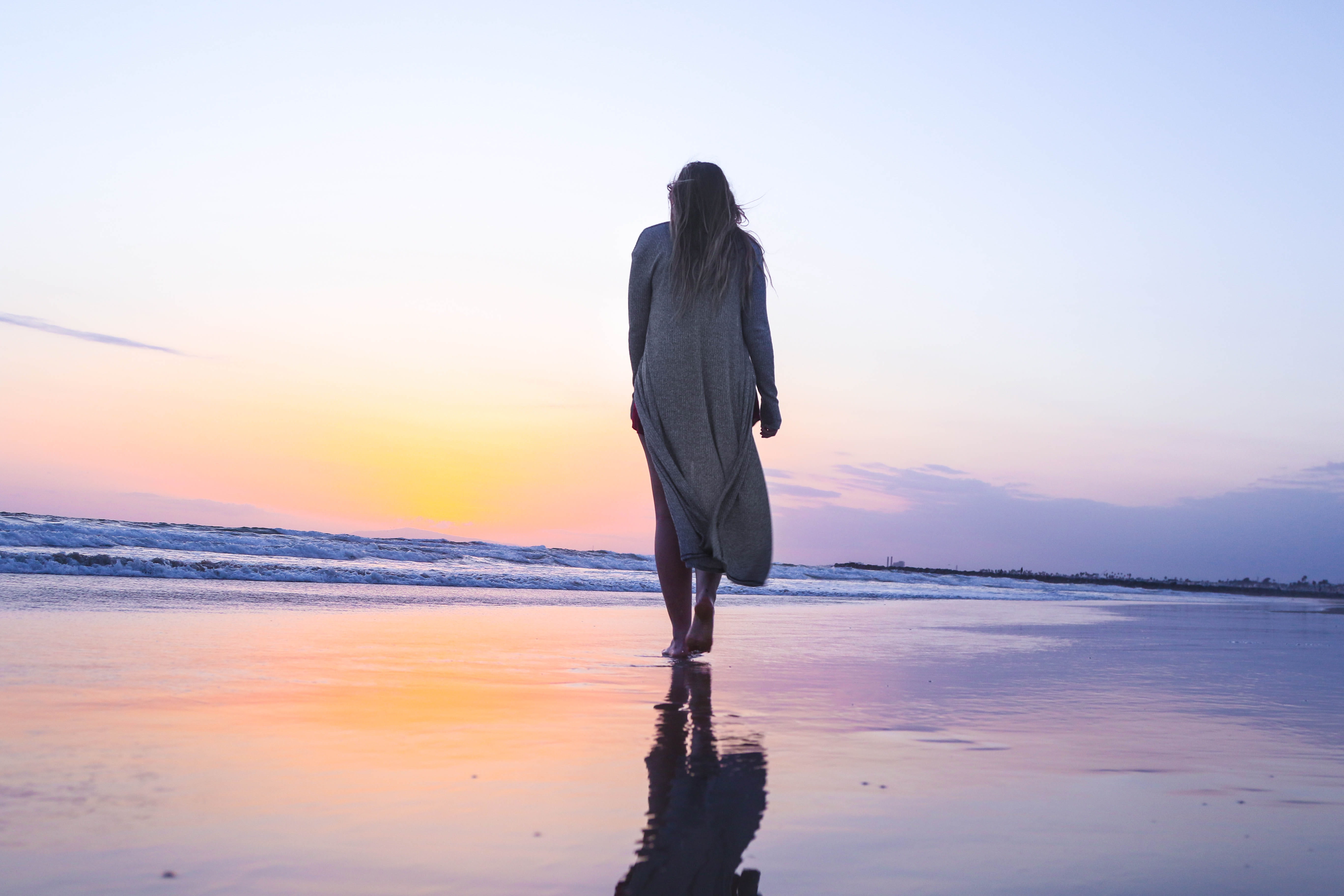 woman standing on beachfront walking shore white dress 2k 4k 5k
