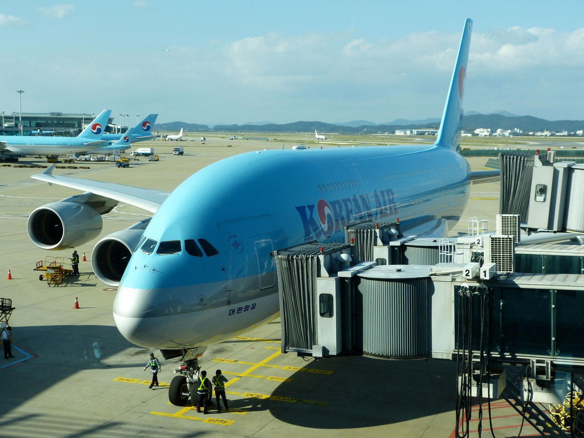 blue and white commercial airplane during daytime airport korean air 2k
