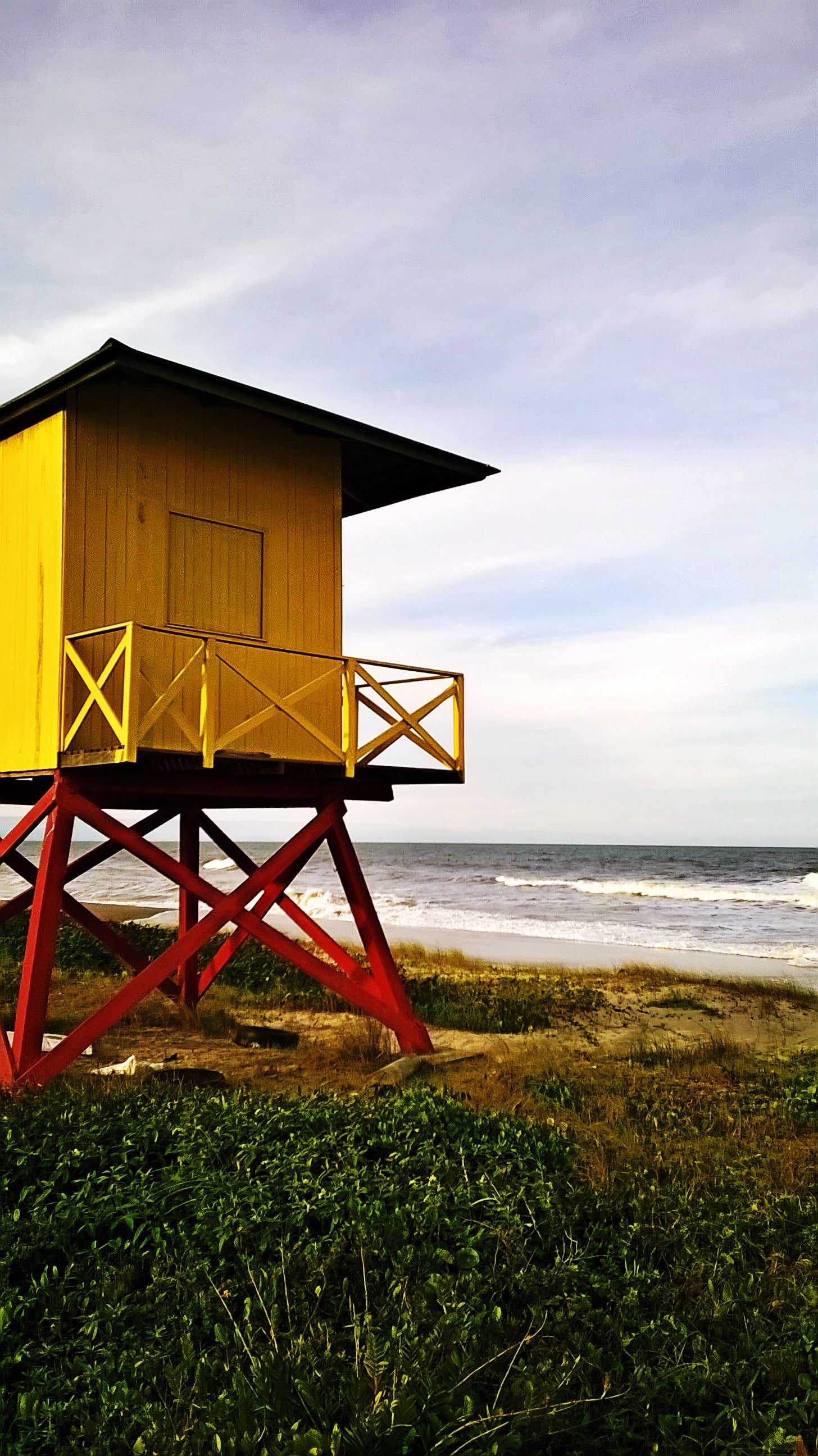 beach land sea architecture water grass sky built structure