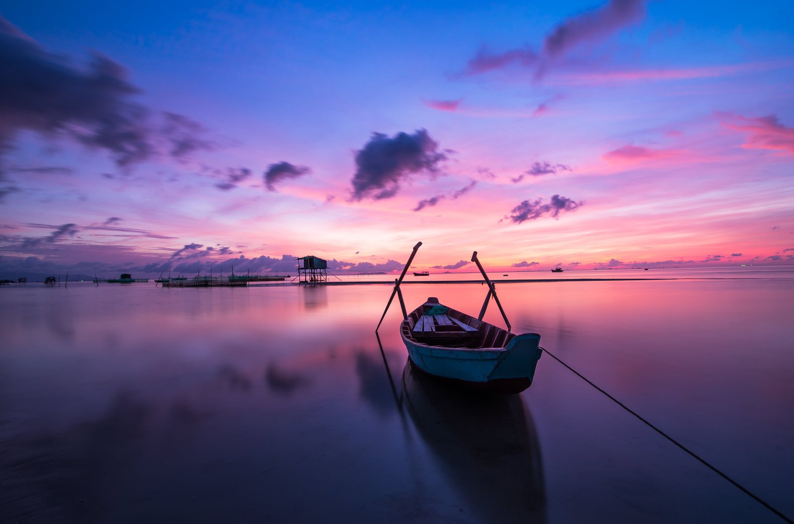 canoe on body of water with blue and pink sky sunrise phu quoc 2k 4k 5k