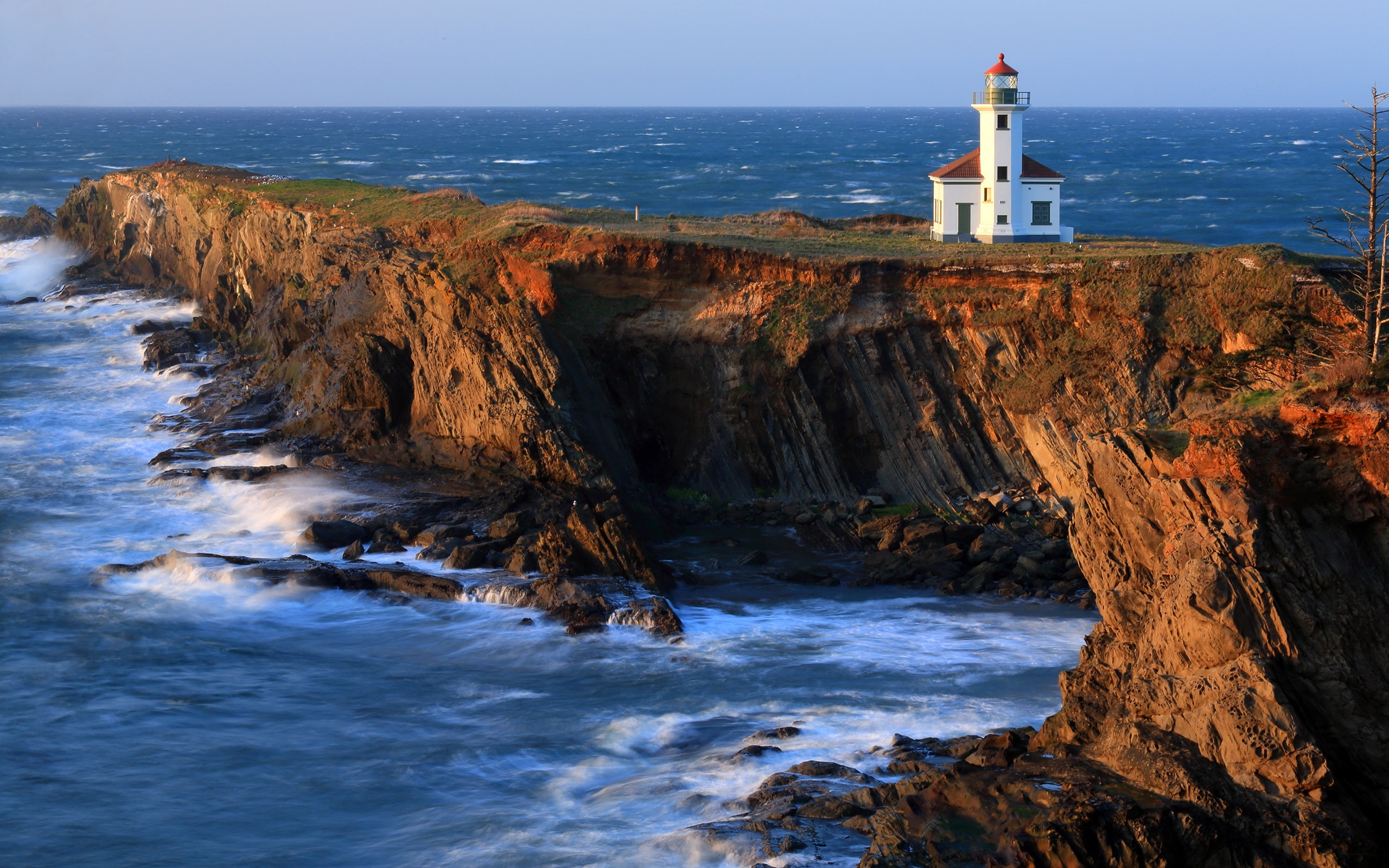 Cape Arago Lighthouse beach coast cliffs Pacific white light house on cliff beside ocean 2k