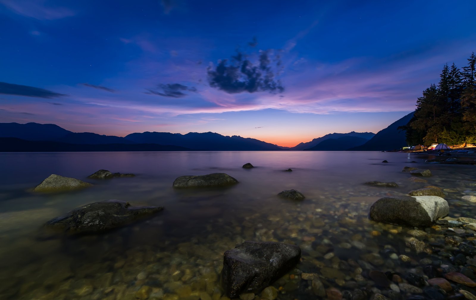 timelapse photography of body water near mountain during golden hour 2k 4k 5k