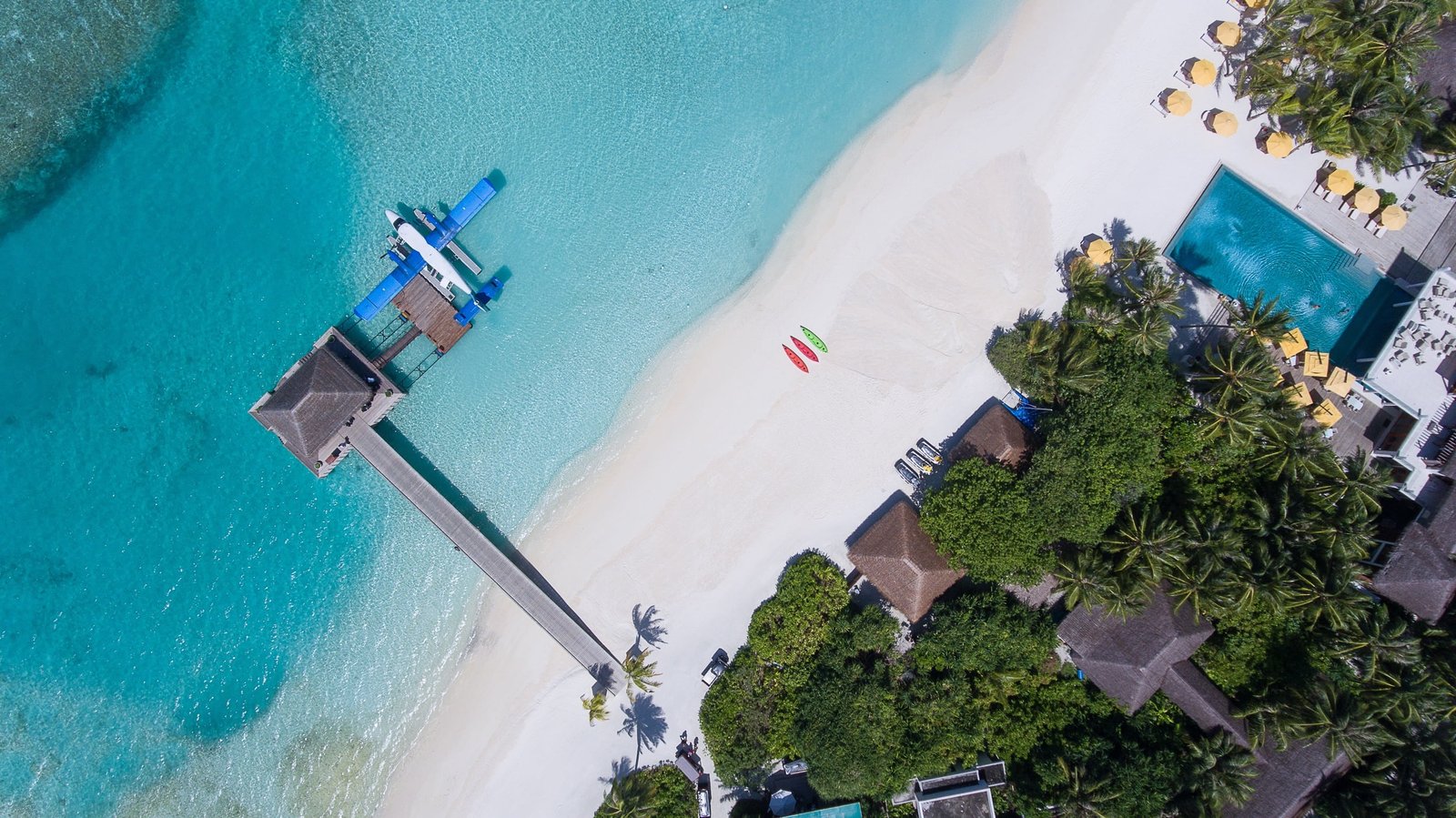 aerial view of beach shore land water ocean sea green blue 2k