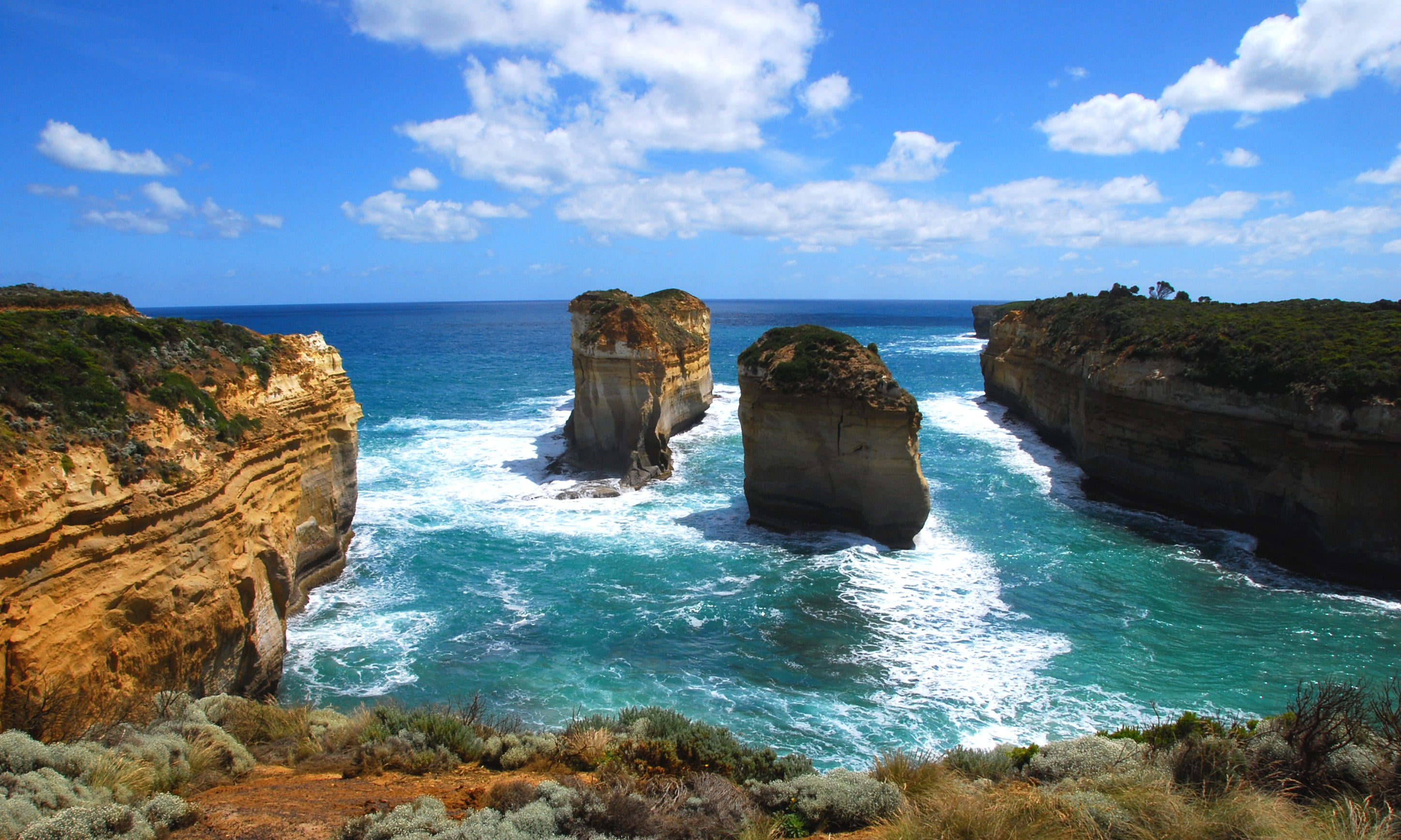 mountain near body of water under cloudy sky great ocean road 2k