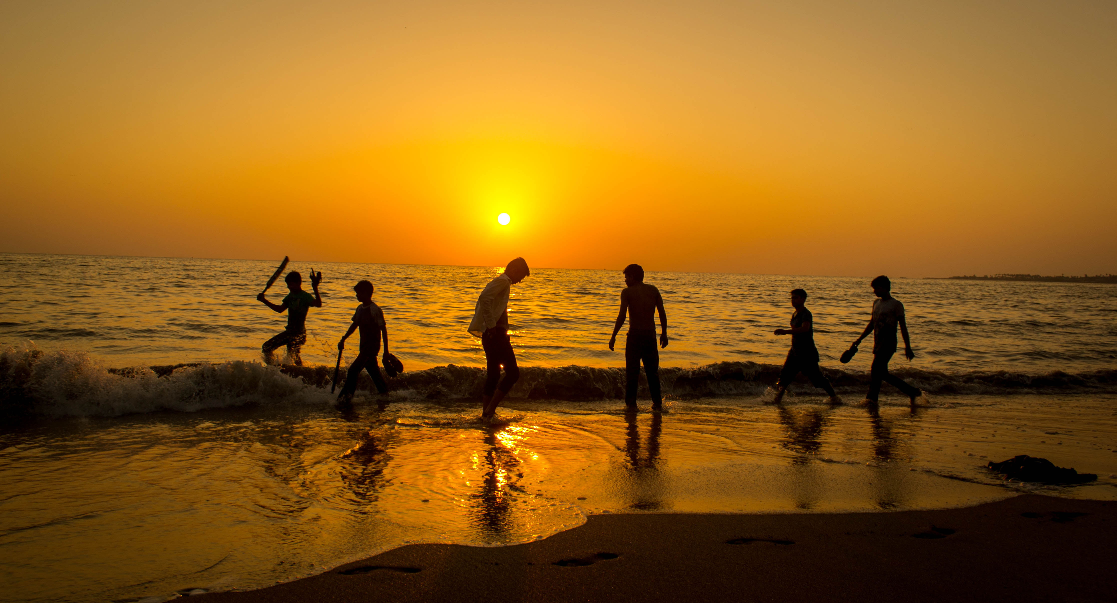 silhouette of mans standing seashore during sunset beach cricket 2k 4k