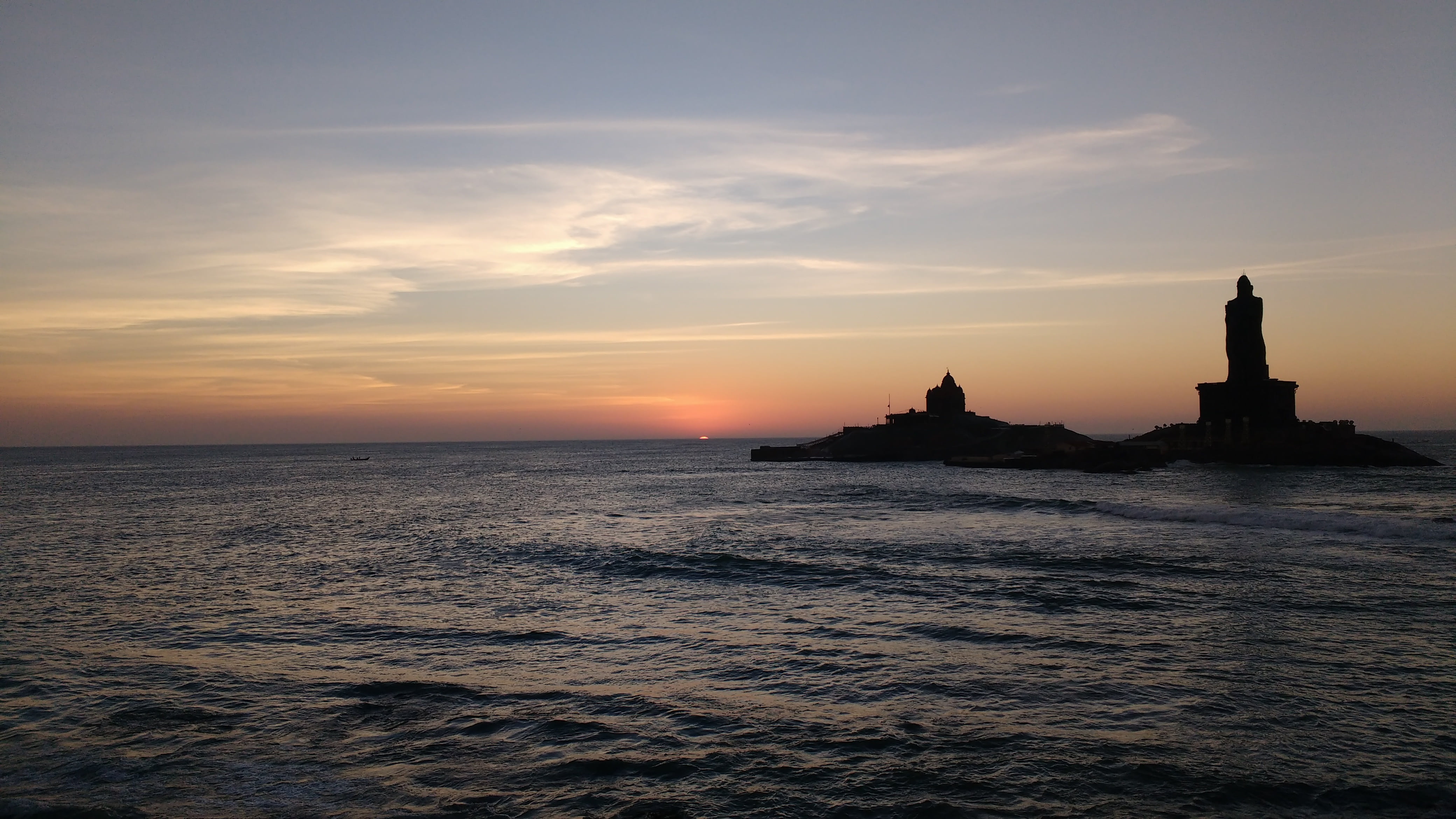 lighthouse beside body of water under calm sky kanyakumari sunrise 2k 4k