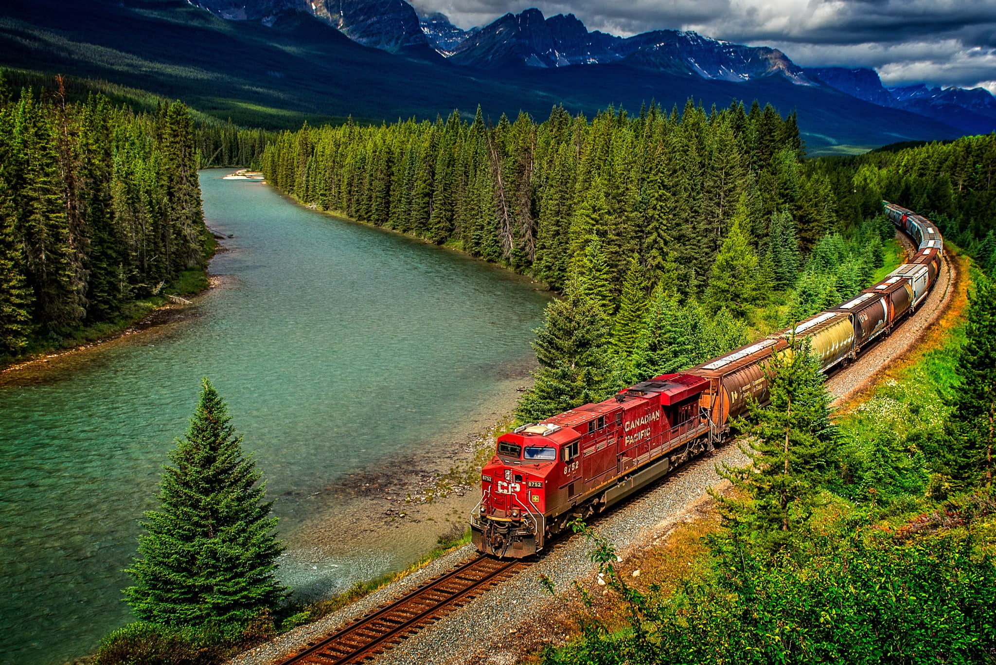 red brown and yellow locomotive train forest trees mountains 2k