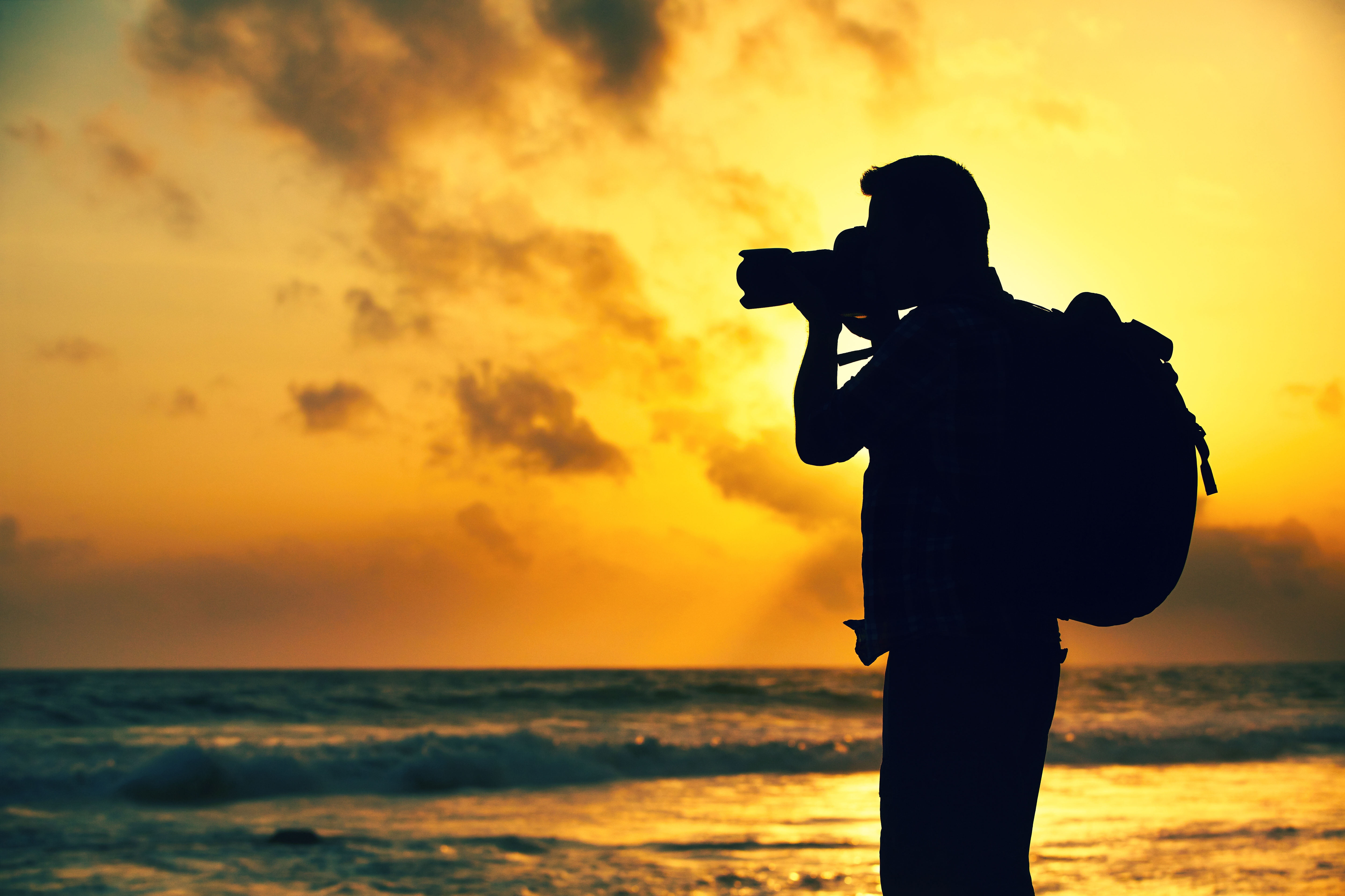 DSLR camera and backpack sea sunset nature background people 2k 4k 5k