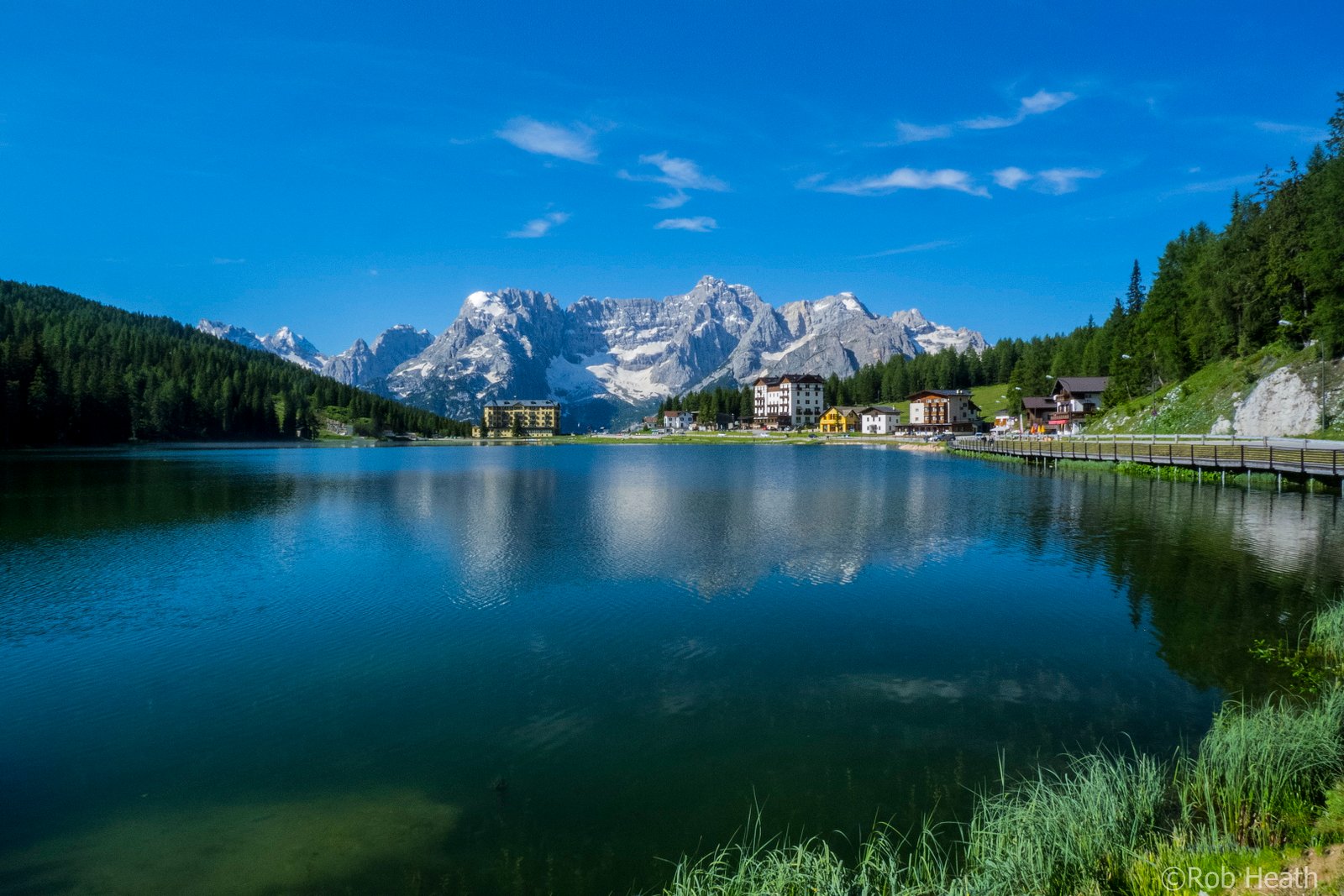 landscape photography of mountain near body water surrounded by pine trees lake misurina 2k