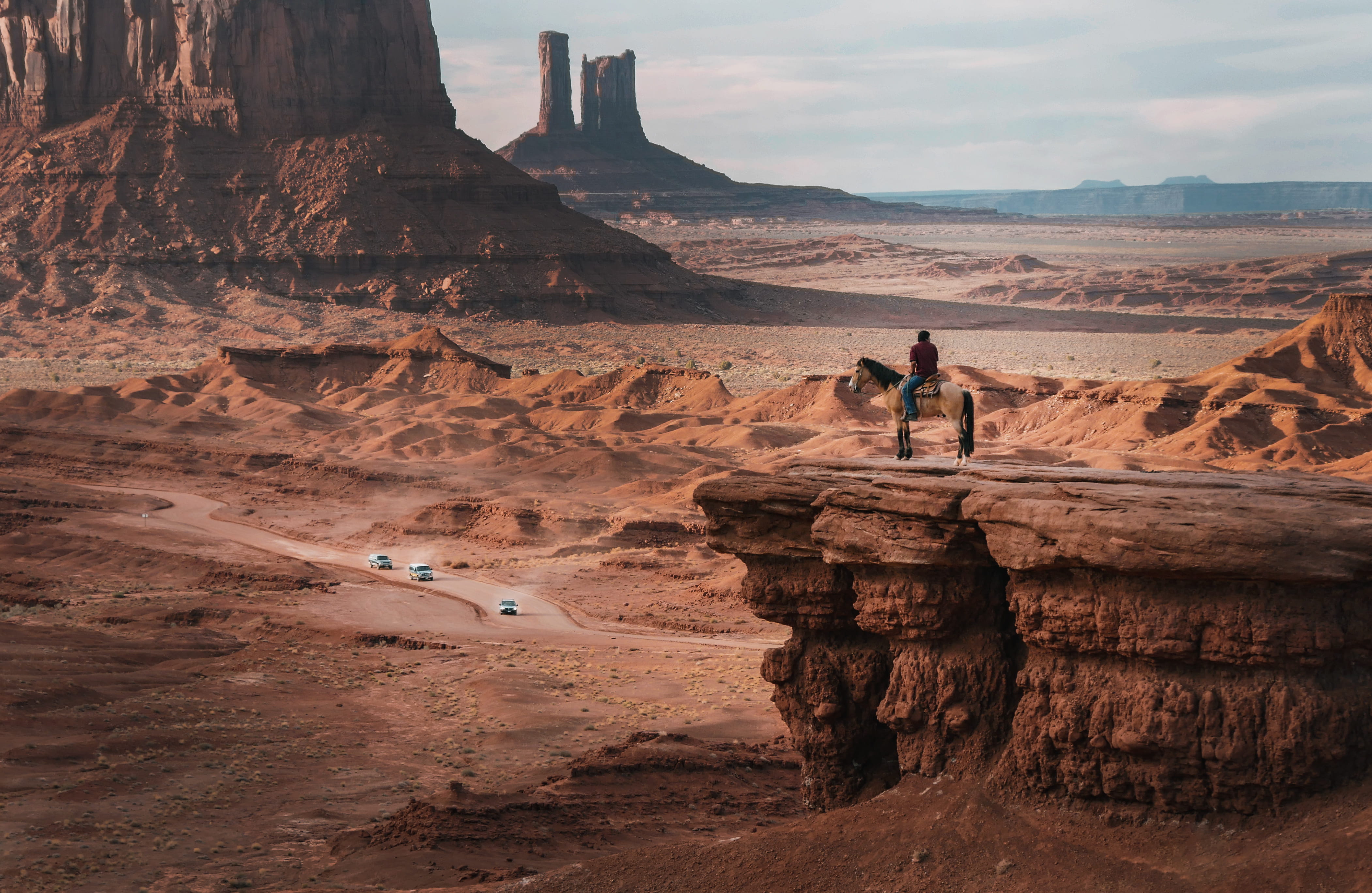 person riding on horse near cliff desert landscape arizona 2k 4k