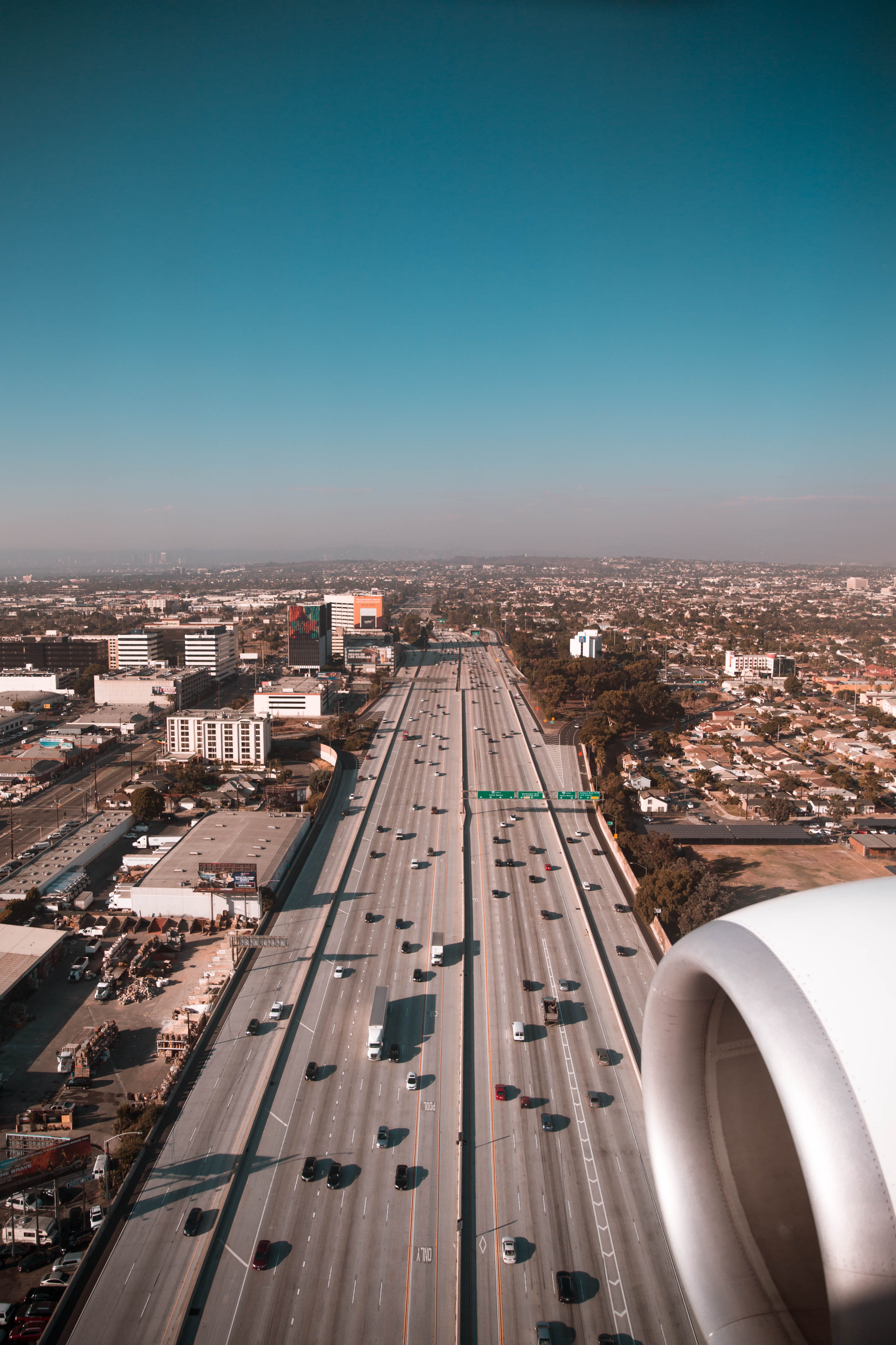 aerial view of cars on road plane engine highway city cityscape 2k 4k