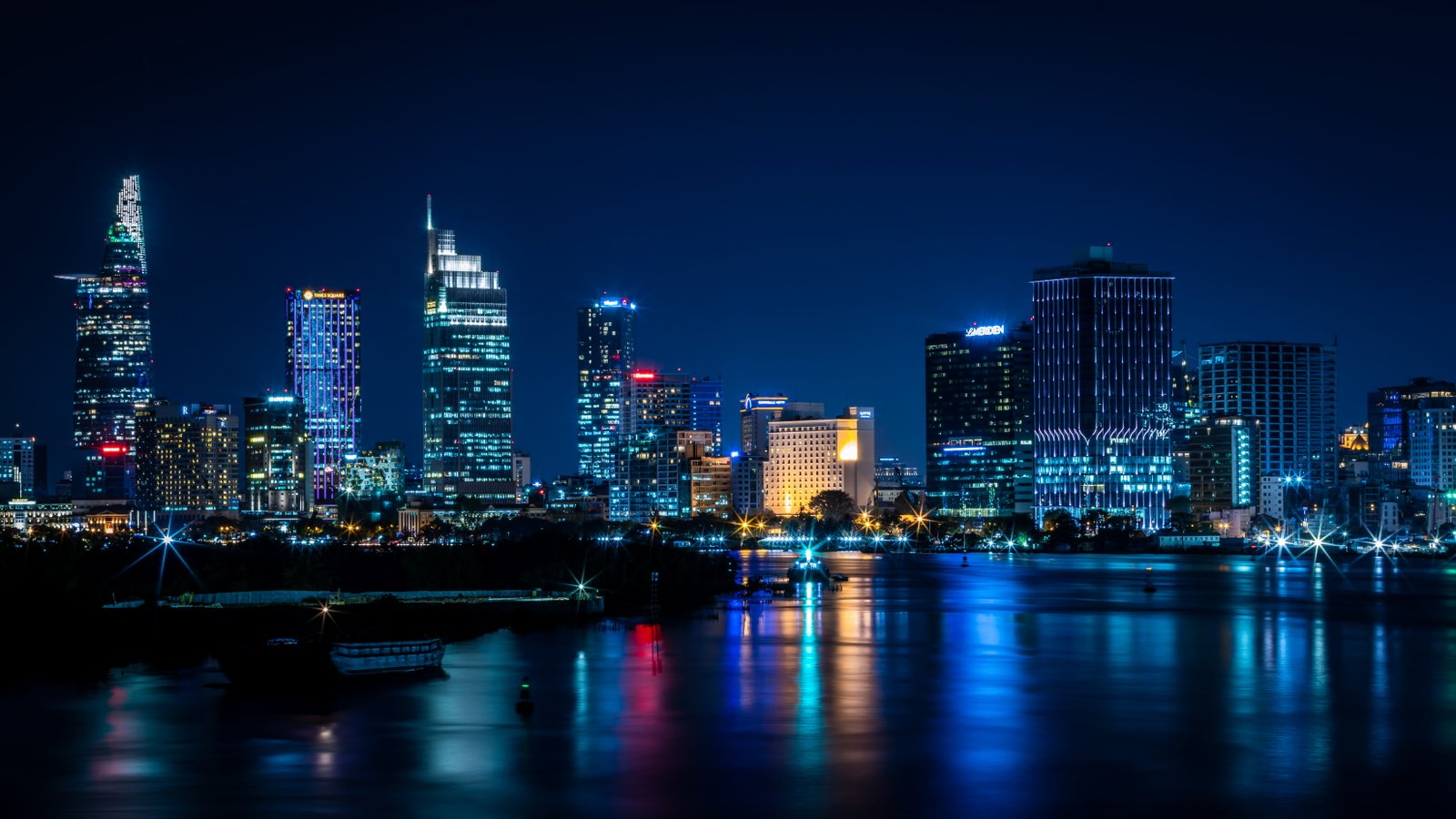 buildings near body of water during nighttime town city urban 2k 4k 5k