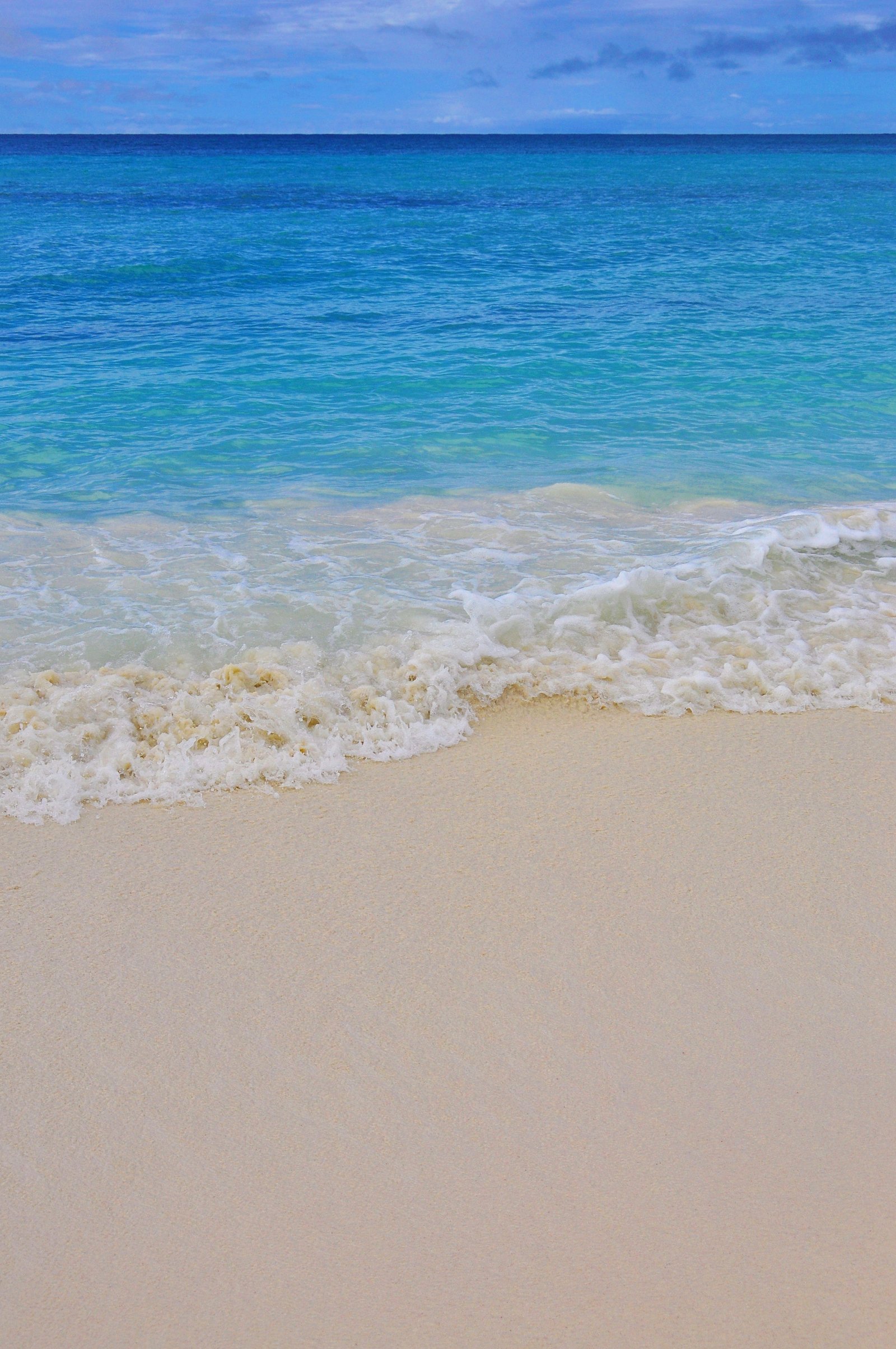 cloudy sky over sea caribbean beach sand wave background 2k