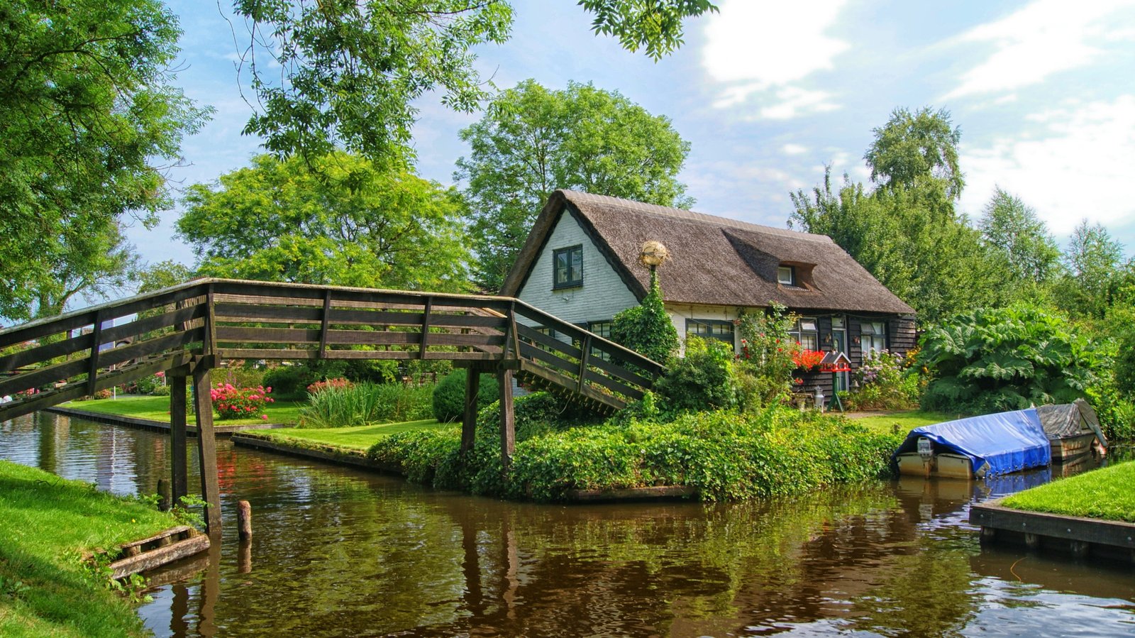 landscape photography of brown house near bridge across body water at daytime 2k 4k