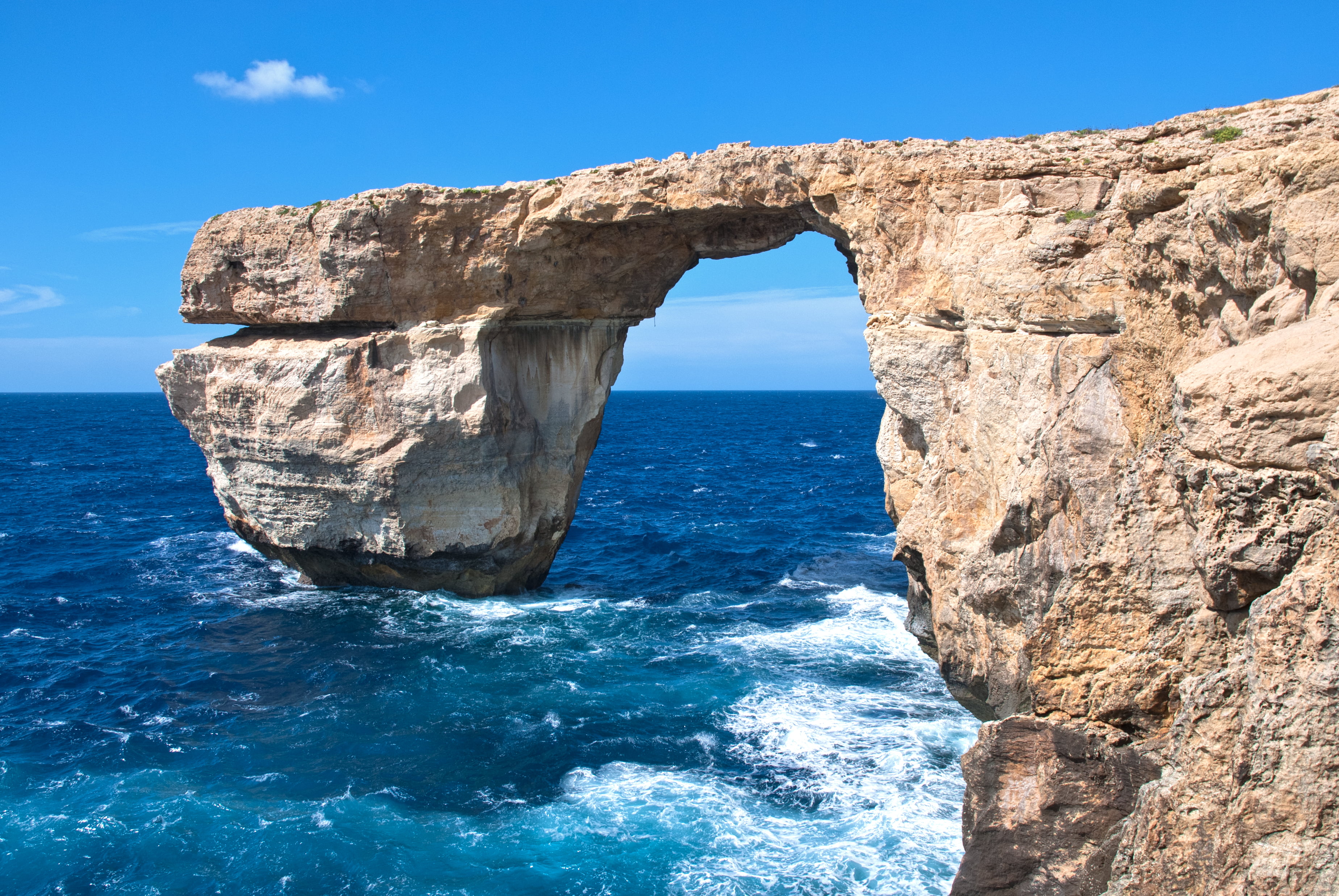 brown rock formation on body of water during day time malta gozo 2k 4k