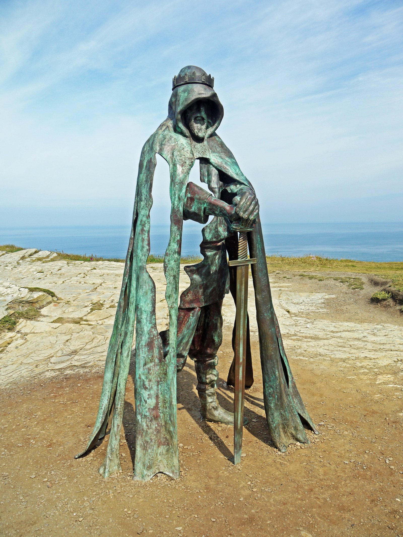 man holding sword statue during daytime king artus metal sculpture 2k