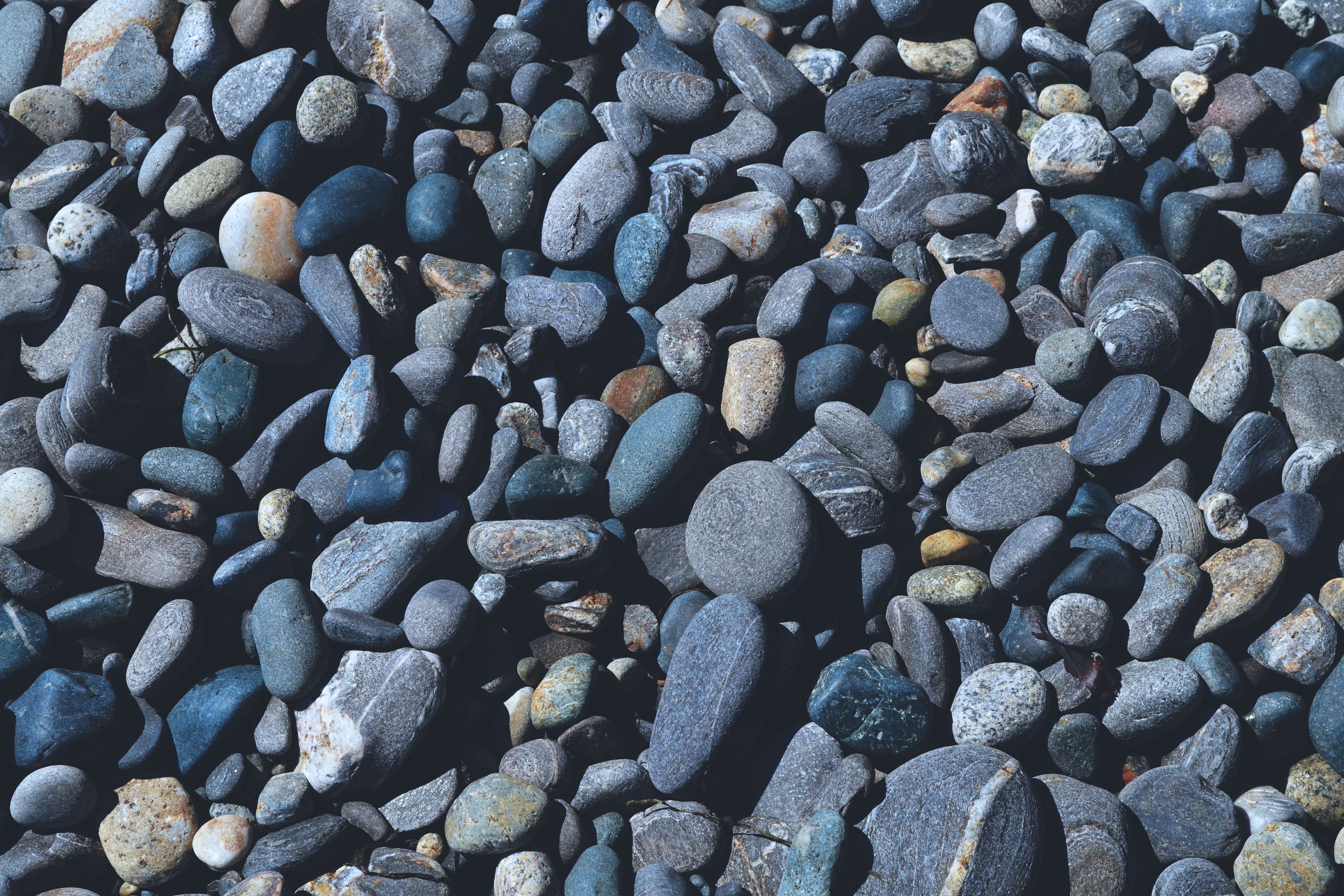 Overhead shot of pebbles on the beach textures abstract coast 2k 4k 5k
