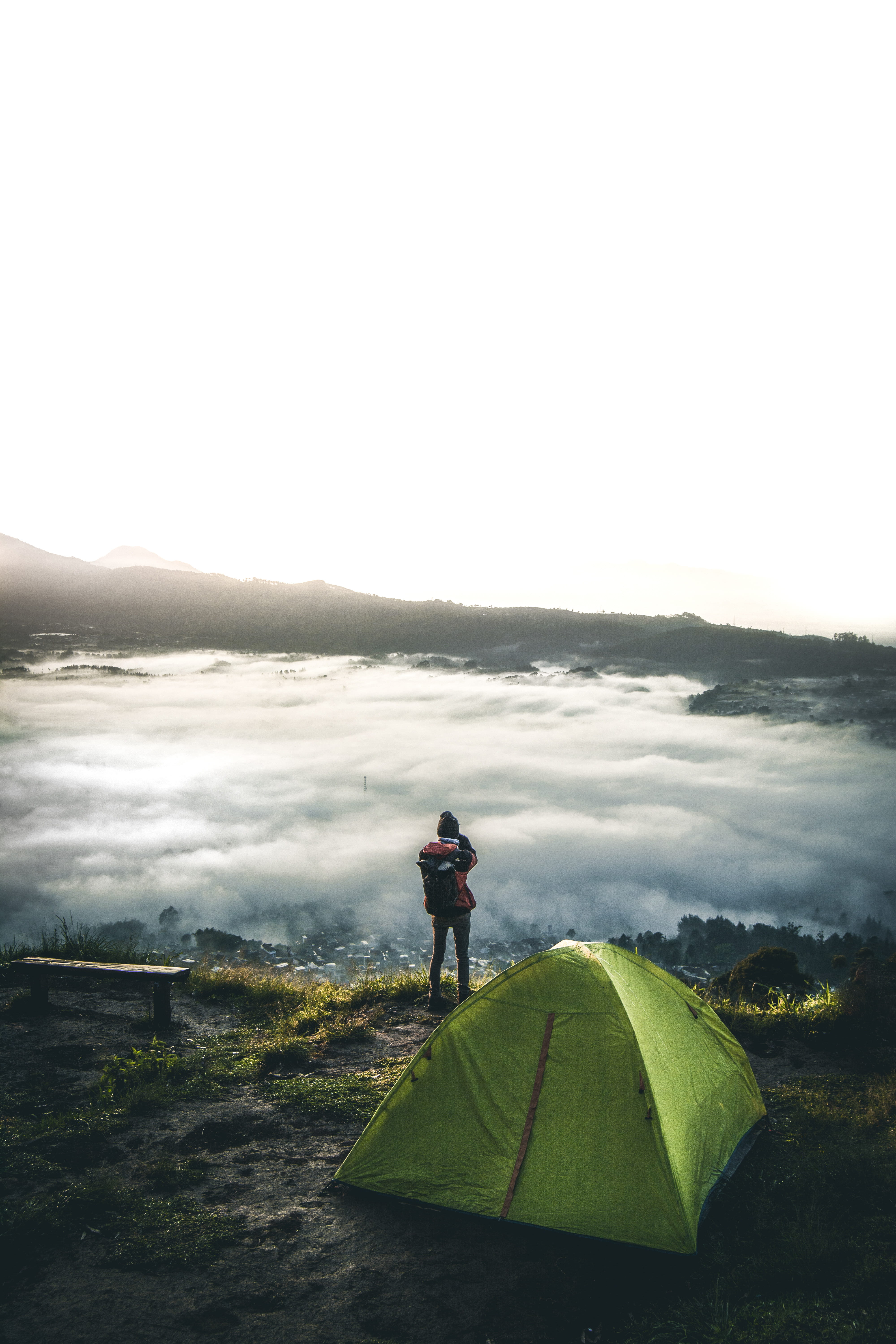 person standing beside tent overlooking white clouds human camping 2k 4k