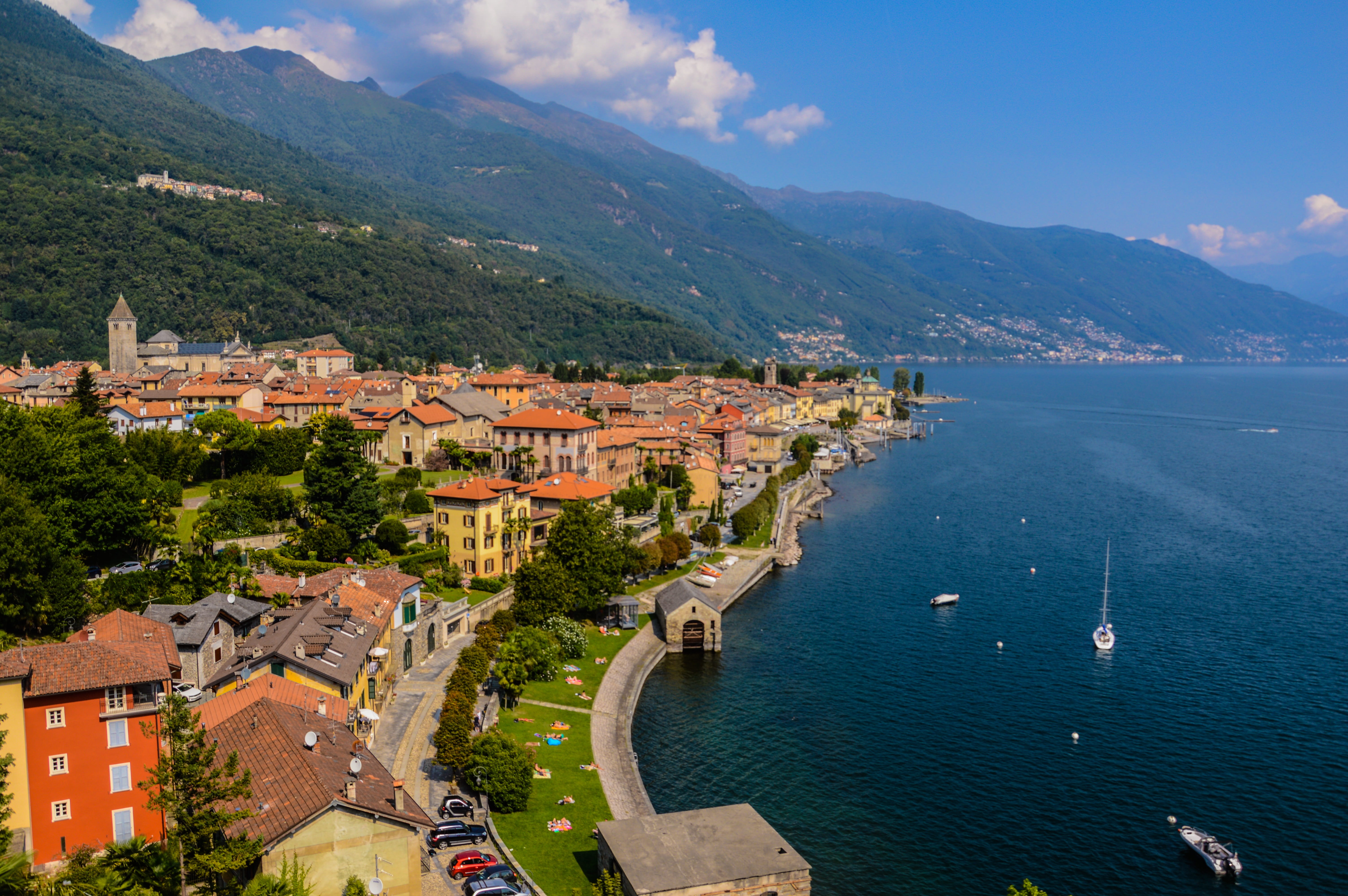 aerial photography of houses beside body water lago maggiore 2k 4k 5k