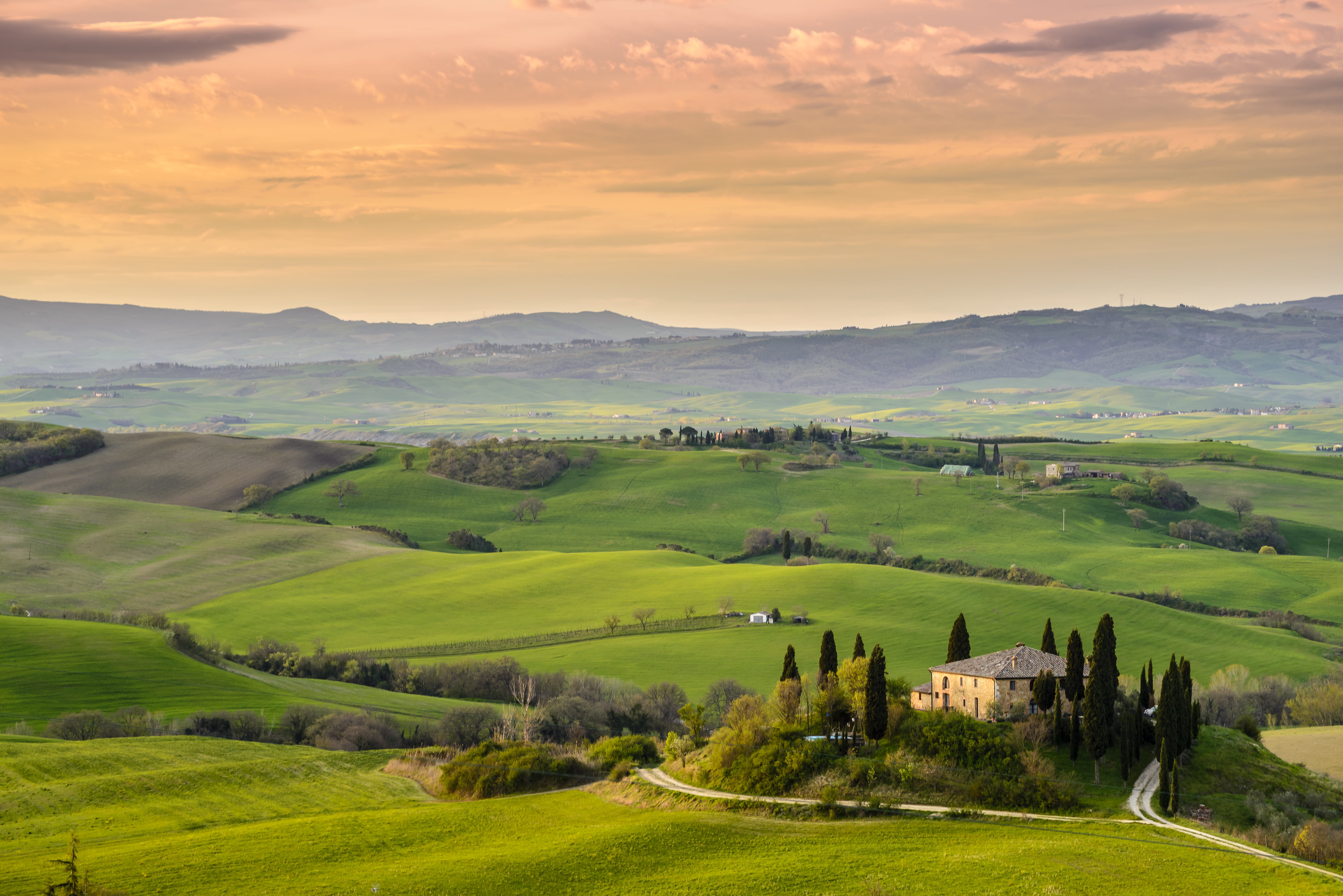 photo of yellow and brown concrete house surrounded with green trees field grasses val d orcia 2k 4k 5k