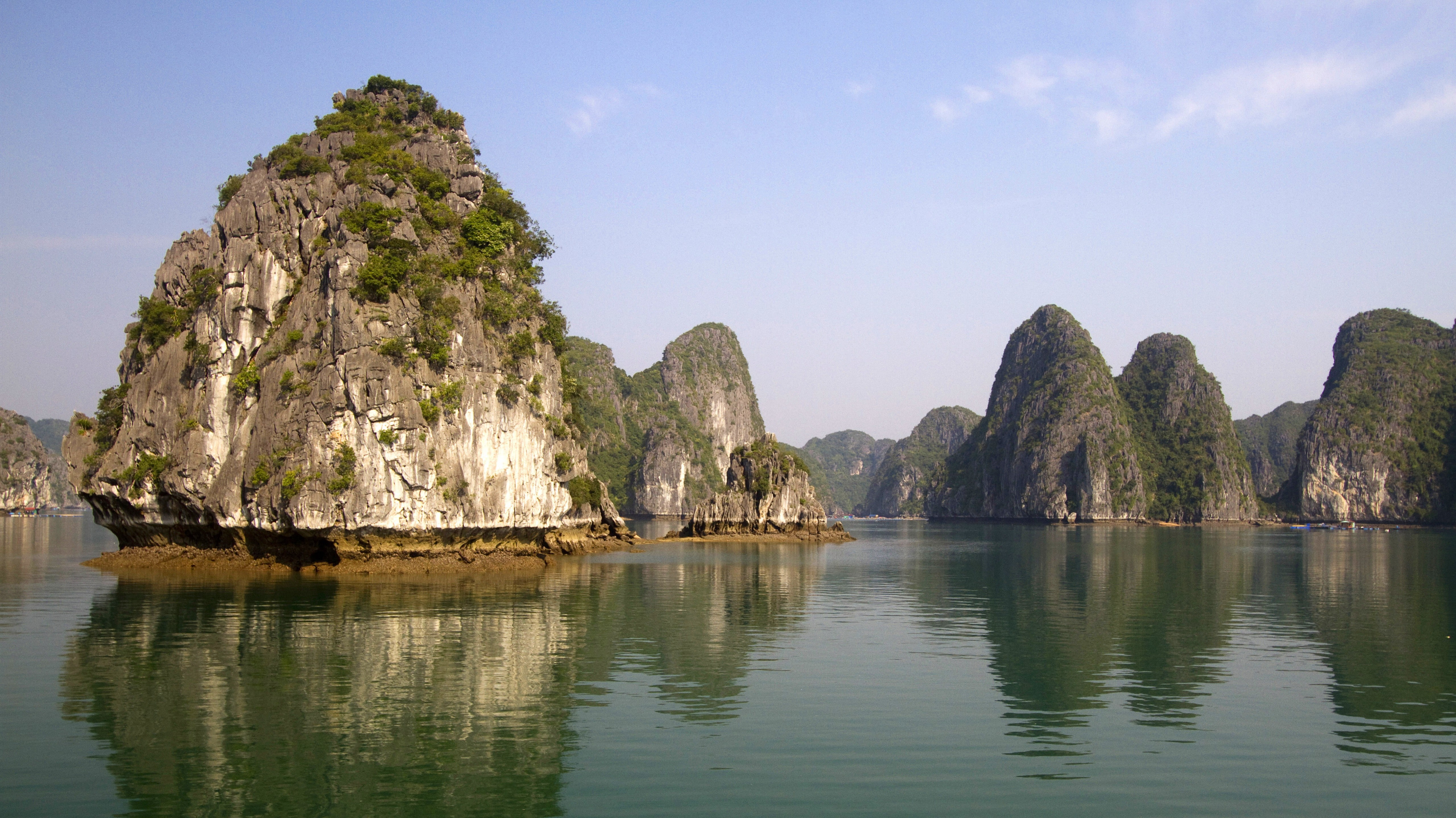rock monument on calm body of water during daytime Ha Long Bay 2k 4k 5k