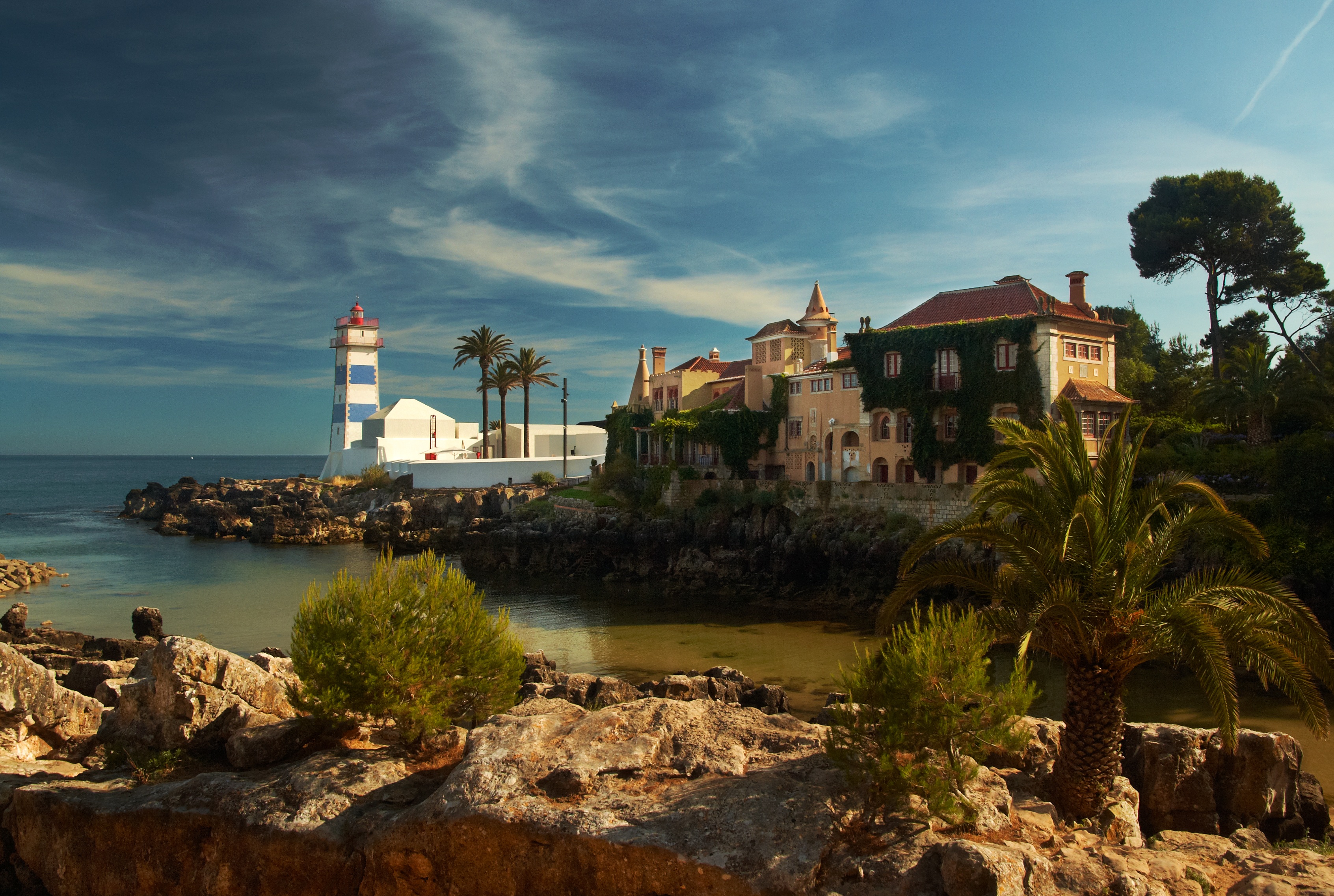 white light house near to mansion overlock the ocean cascais 2k
