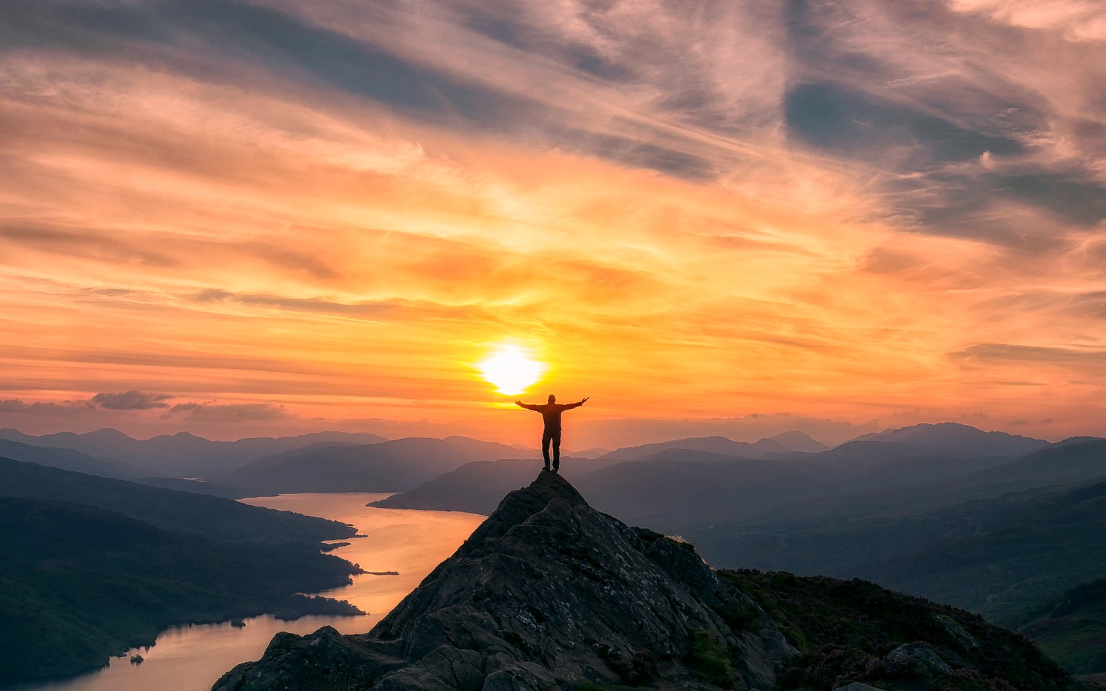 photo of man on top mountain during sunset Trossachs Scotland 2k 4k 5k