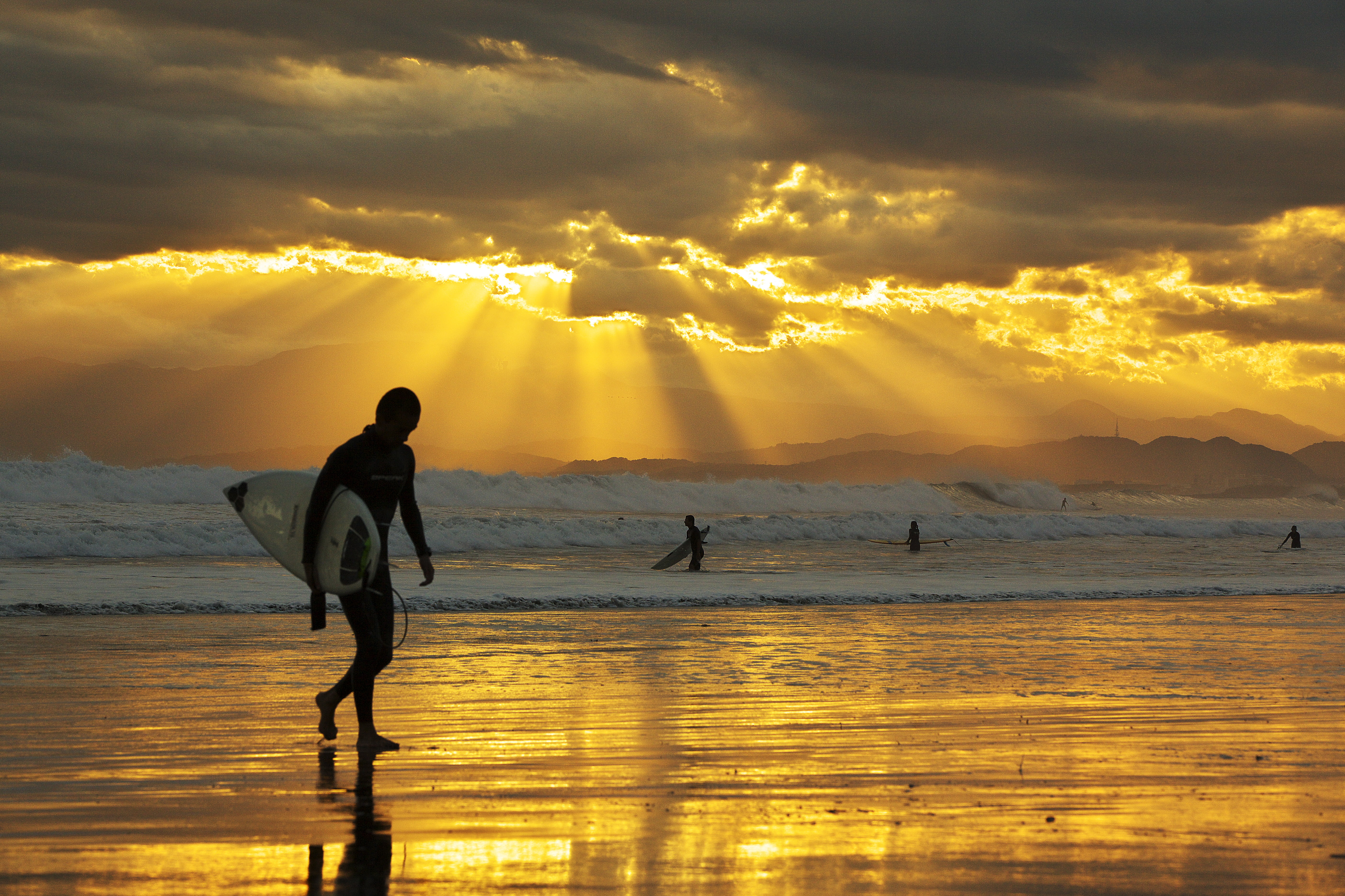 man carrying surfboard beside sea during sunset locals beach 2k 4k 5k