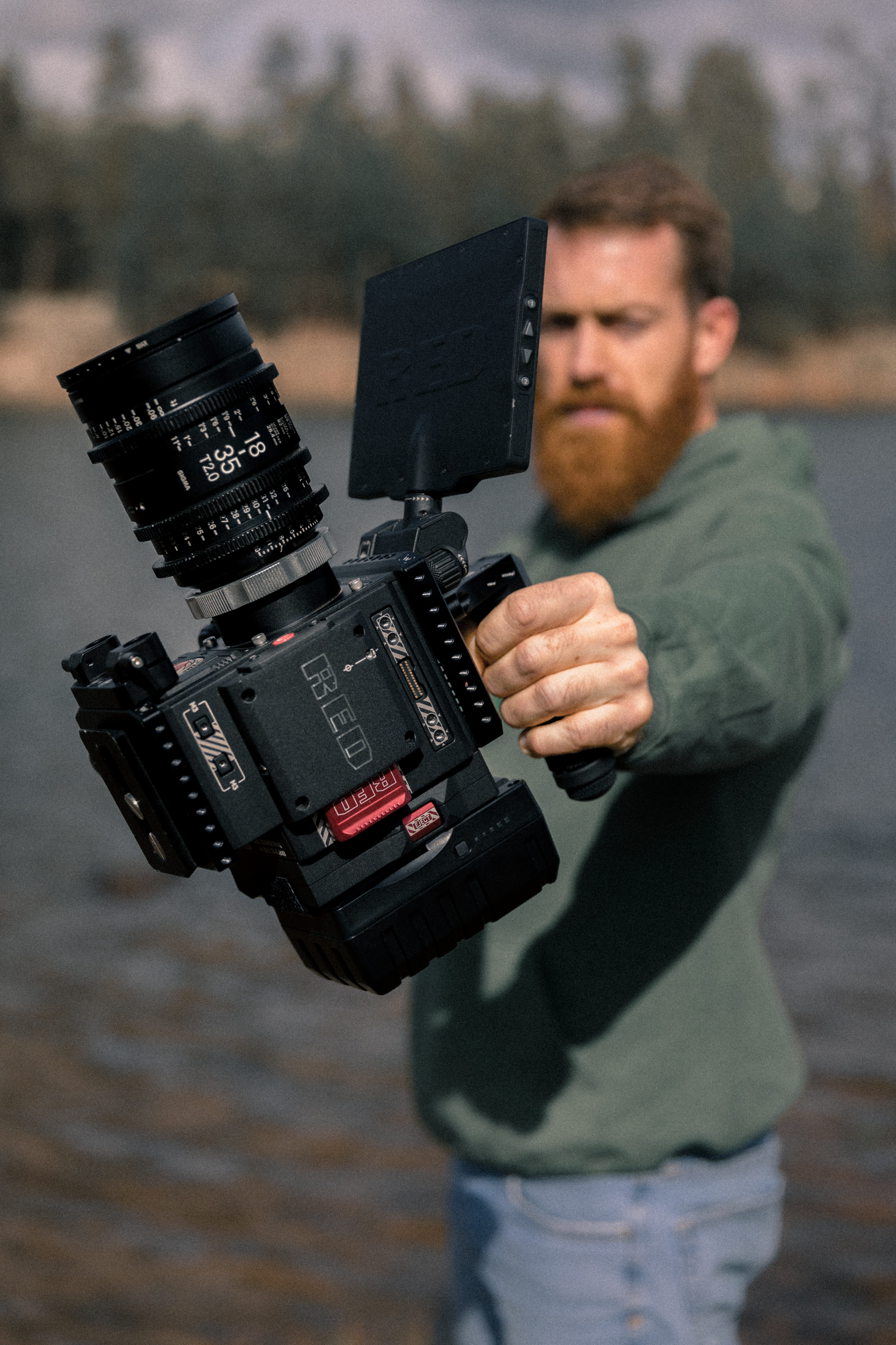 person holding professional video camera red videography cinema 2k 4k