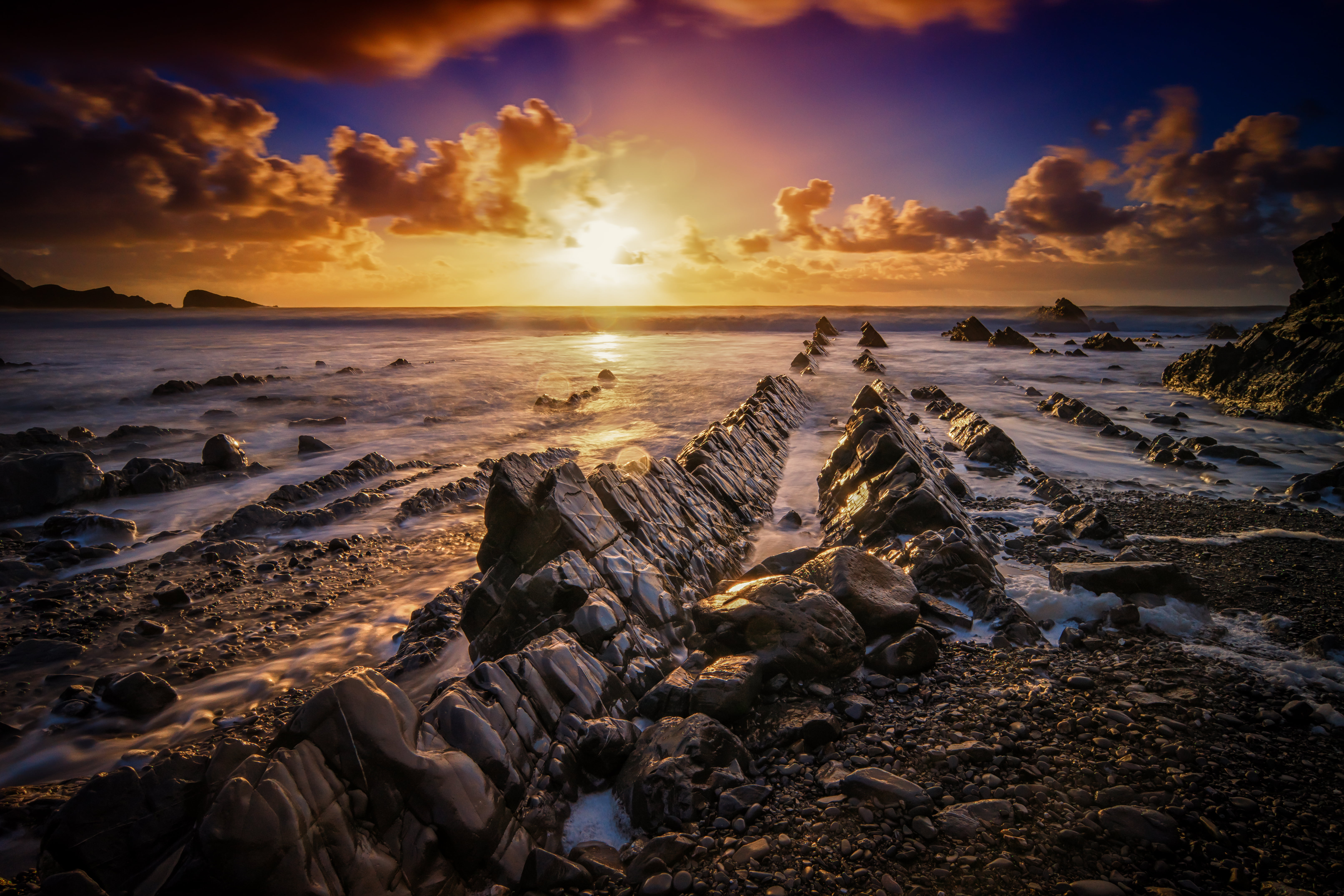 rock formation beside seashore under sunrise photography explored 2k 4k 5k