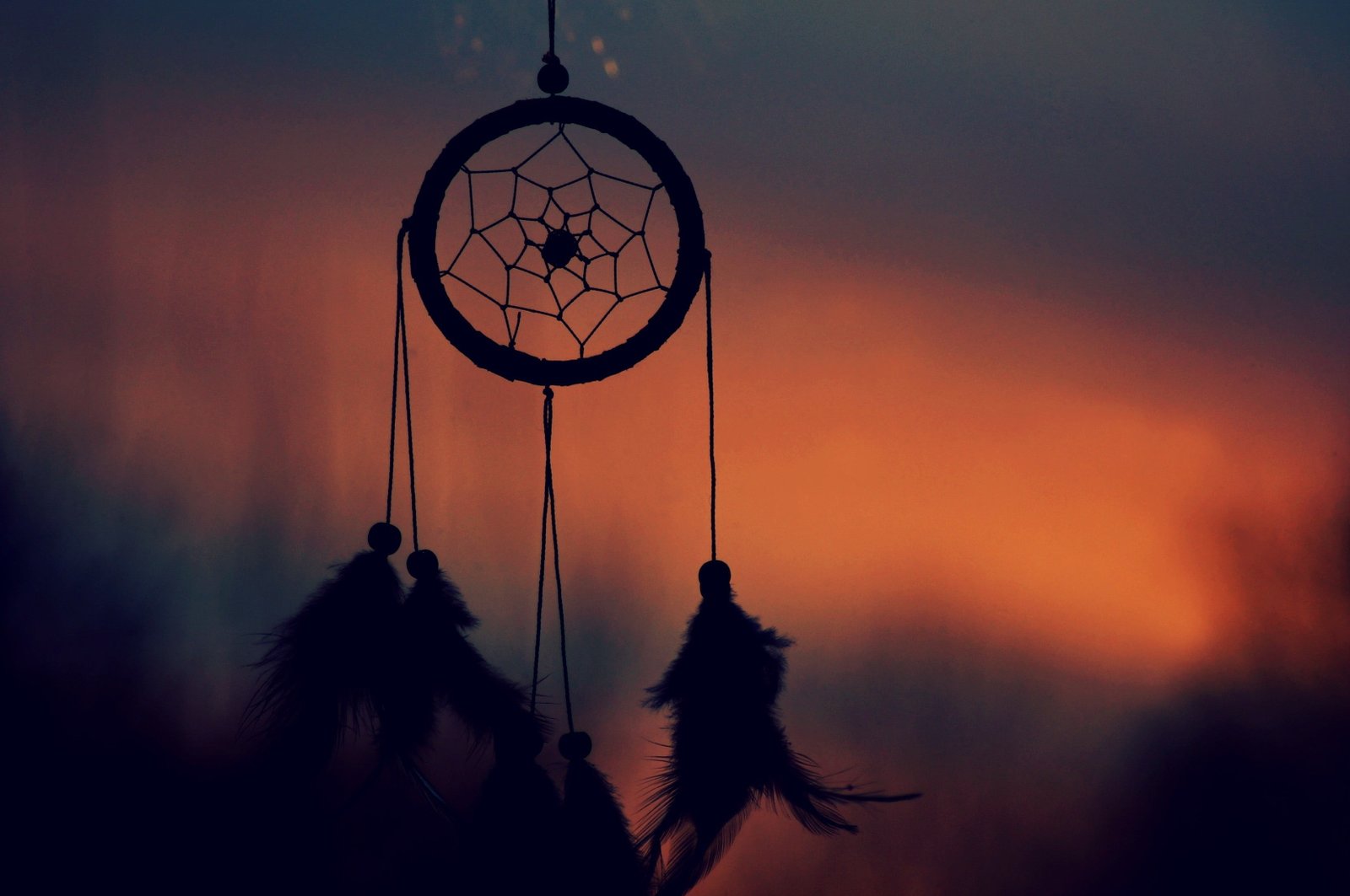 black dream catcher silhouette of hanging under golden hour 2k