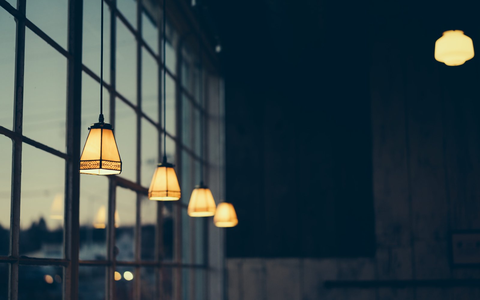 macro shot of black pendant lamps lightened inside room 2k 4k 5k