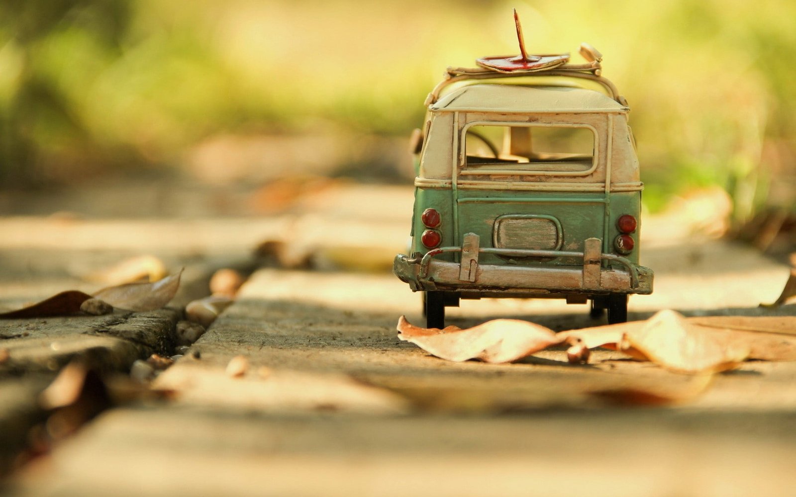 white and teal van scale model tilt shift photography of blue vehicle 2k
