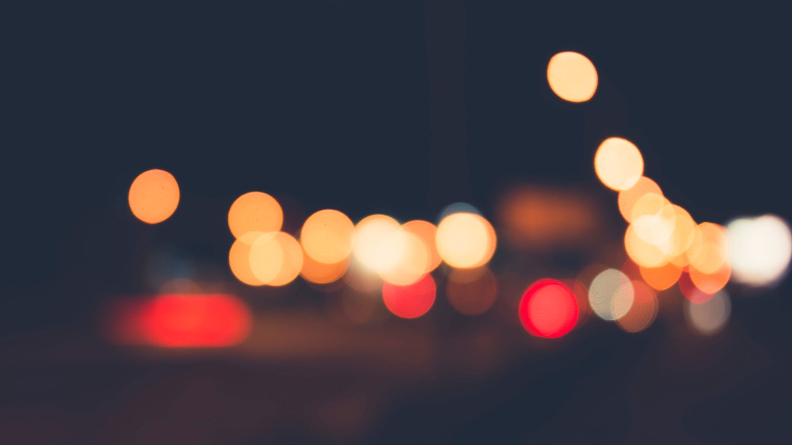 bokeh photography of orange red and black lights blurry night 2k 4k