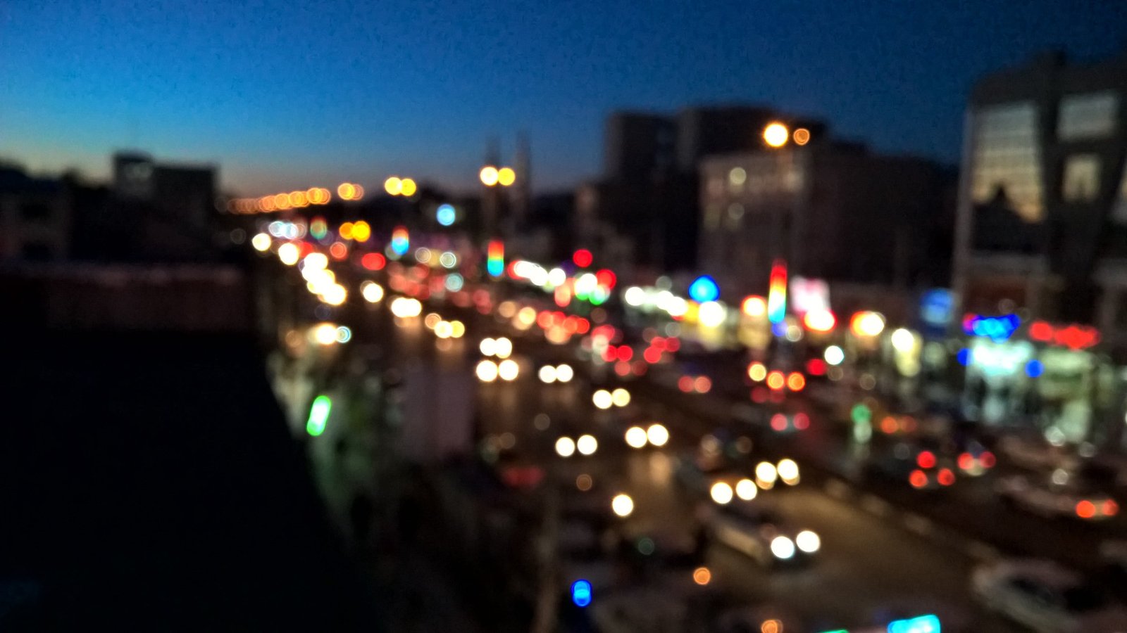 city buildings during sunset bokeh night light painting traffic 2k
