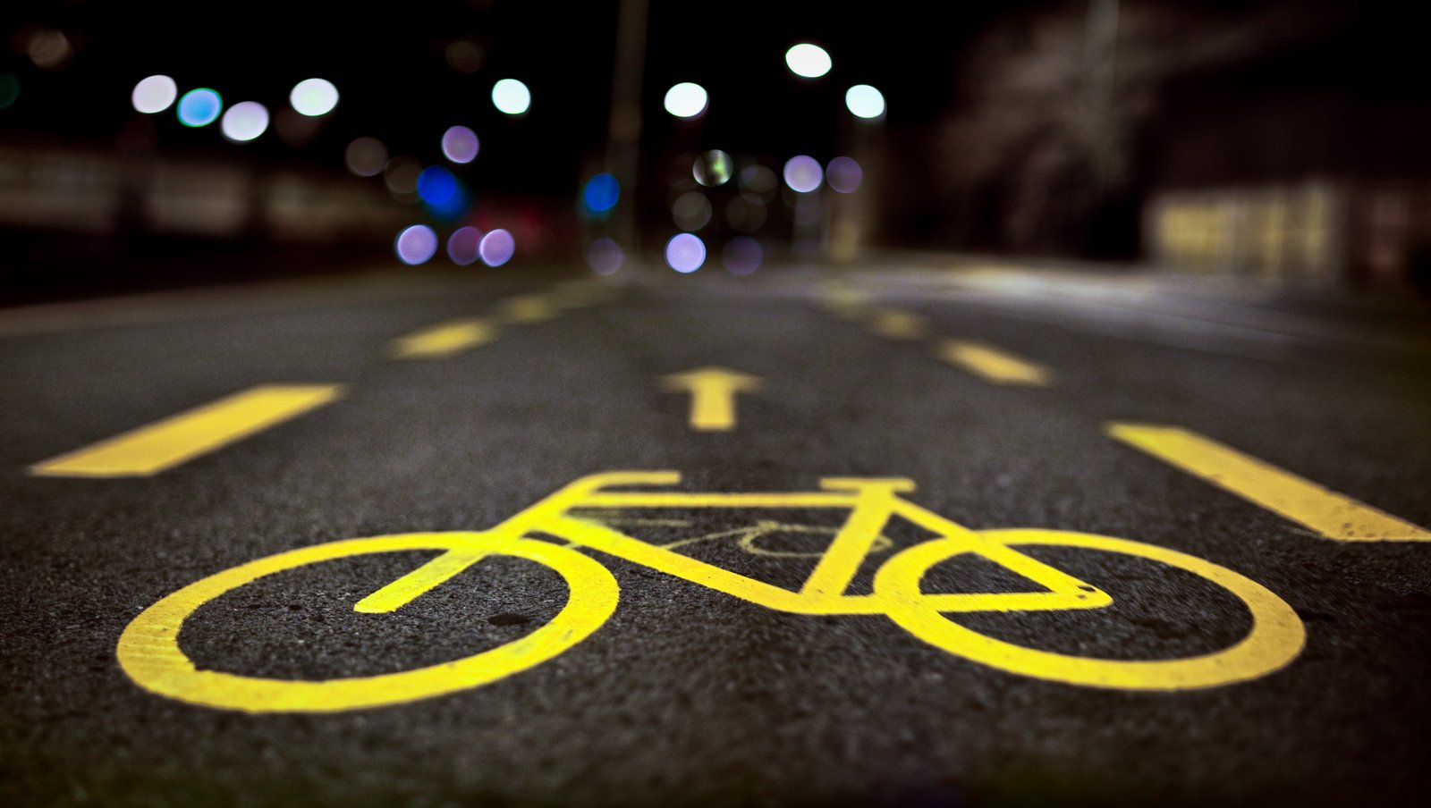 selective focus photography of bike lane signage Dark Riders 2k 4k 5k 8k