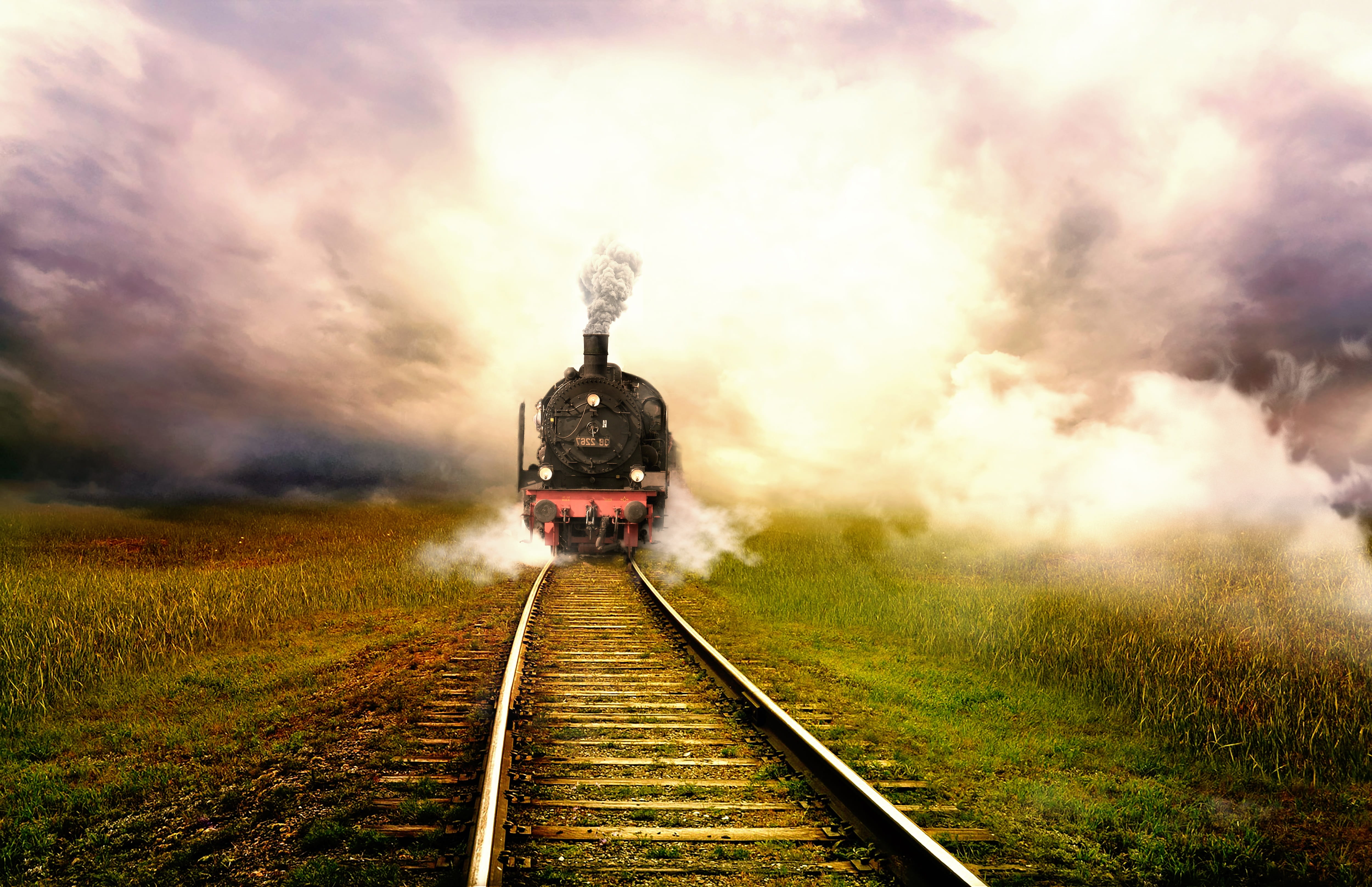 steam engine train travelling on track under white clouds landscape 2k 4k 5k